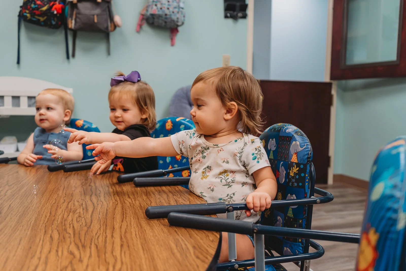 Babies and toddlers sitting around a table during Bible class