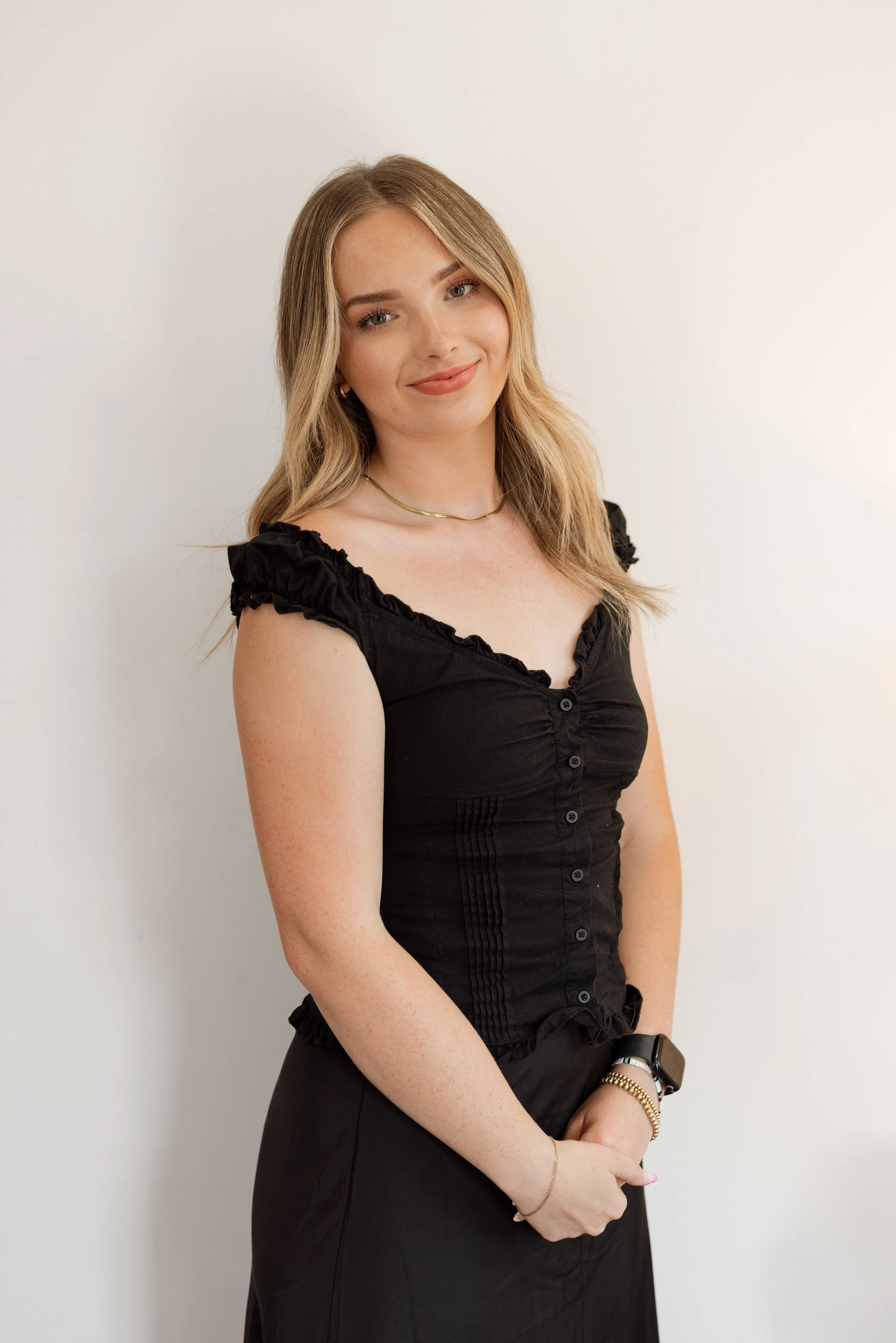 Portrait of front desk coordinator at Refined Aesthetics and Wellness in Logan, Utah – providing excellent customer service and helping clients feel at home