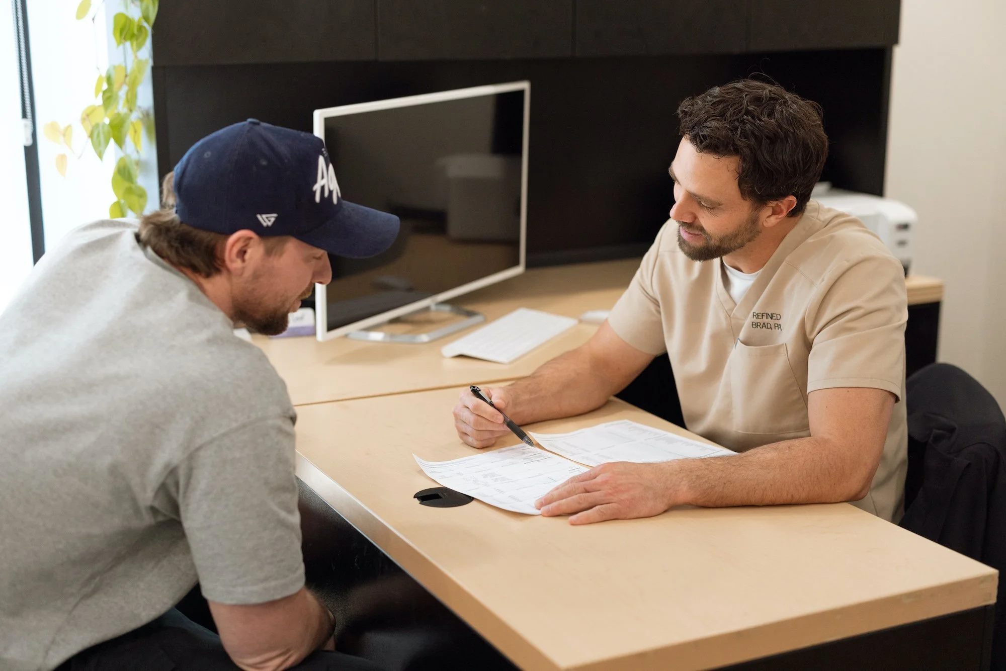 Men’s wellness consultation at Refined Aesthetics and Wellness in Logan, Utah – personalized care including testosterone therapy and aesthetic treatments for men