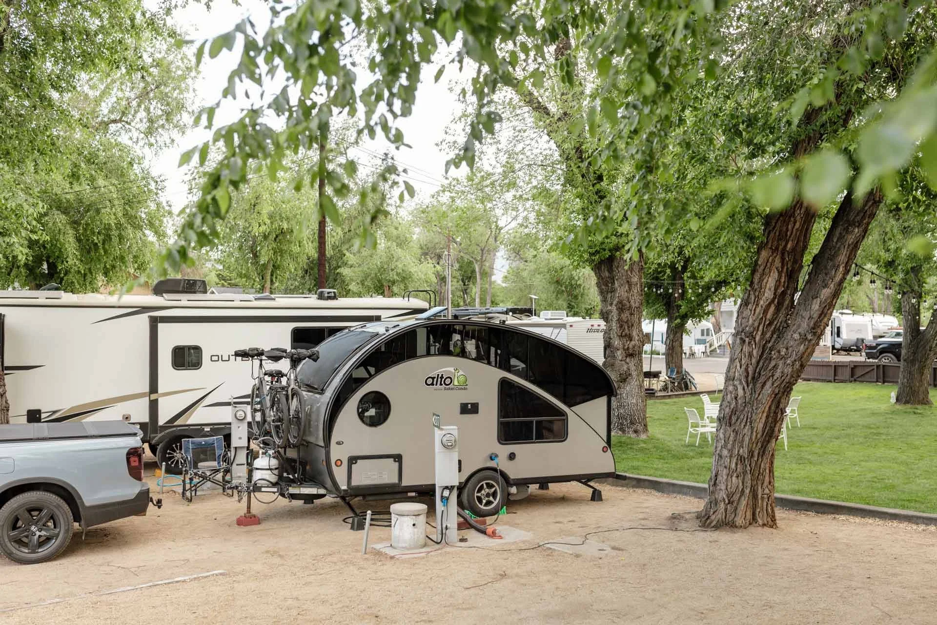 vehicles-parked-at-River-West-Resort-near-green-grass.jpg