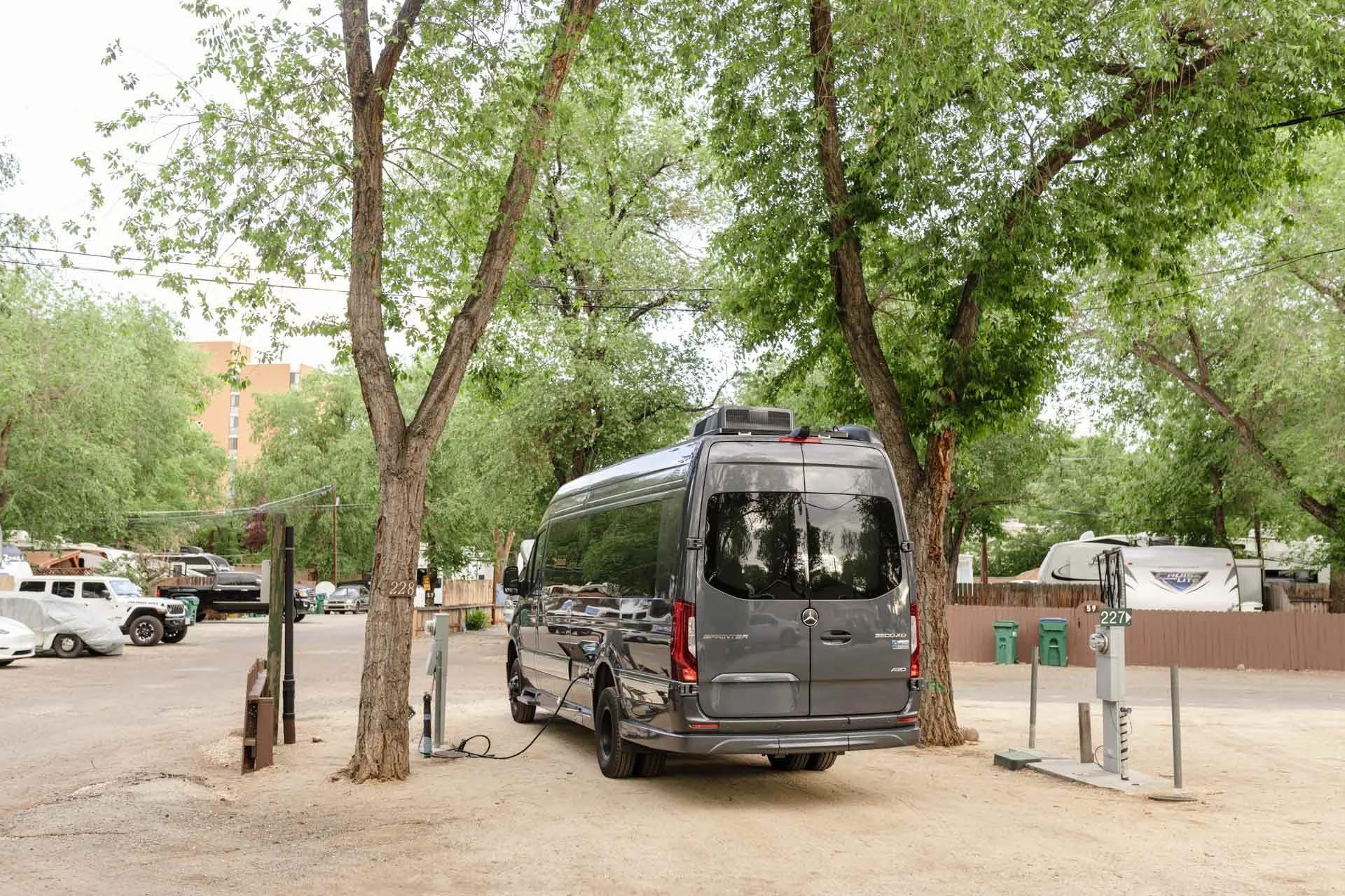 a-vehicle-parked-at-River-West-Resort-under-green-trees.jpg