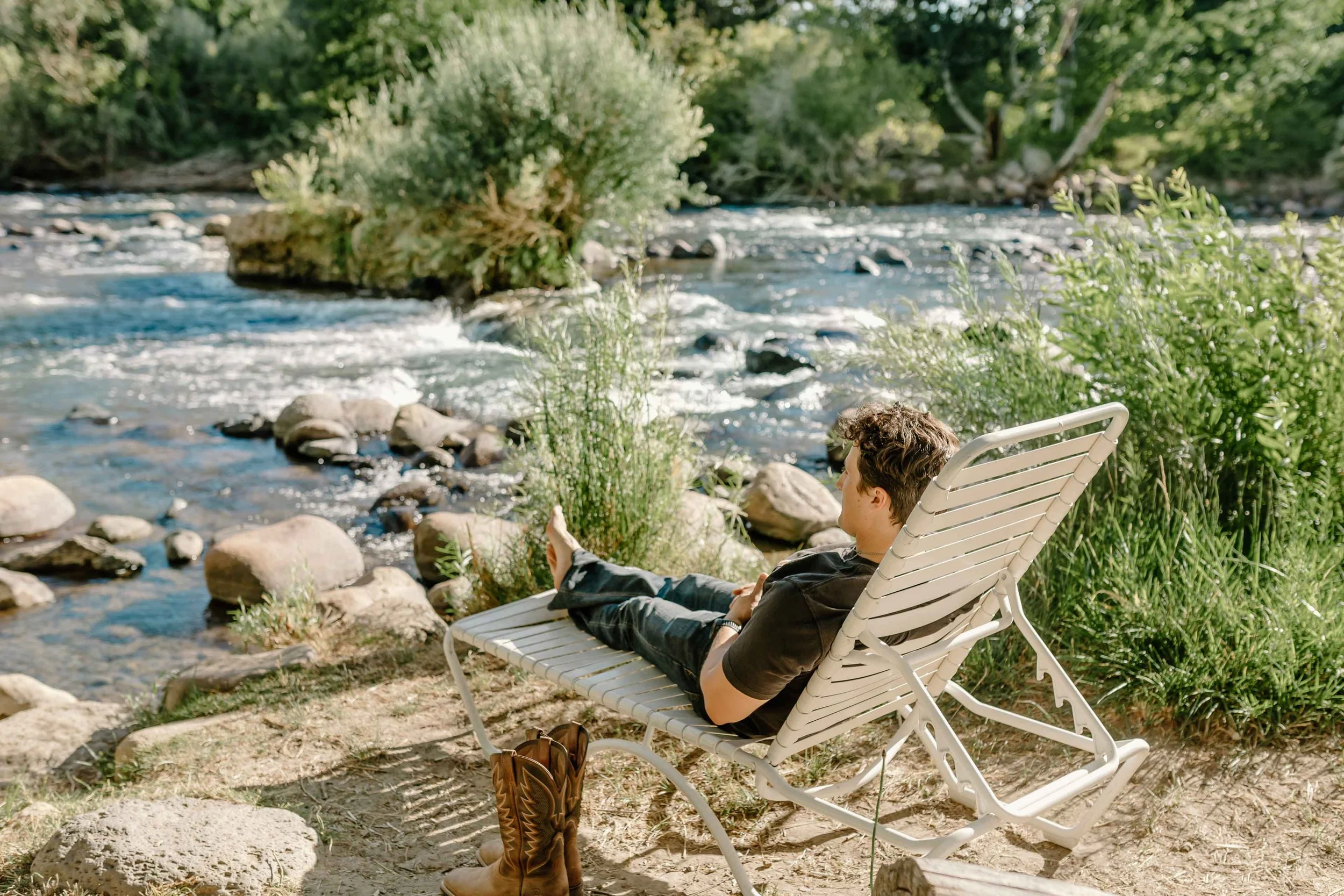 a person relaxing in a chair by the Truckee River.jpg
