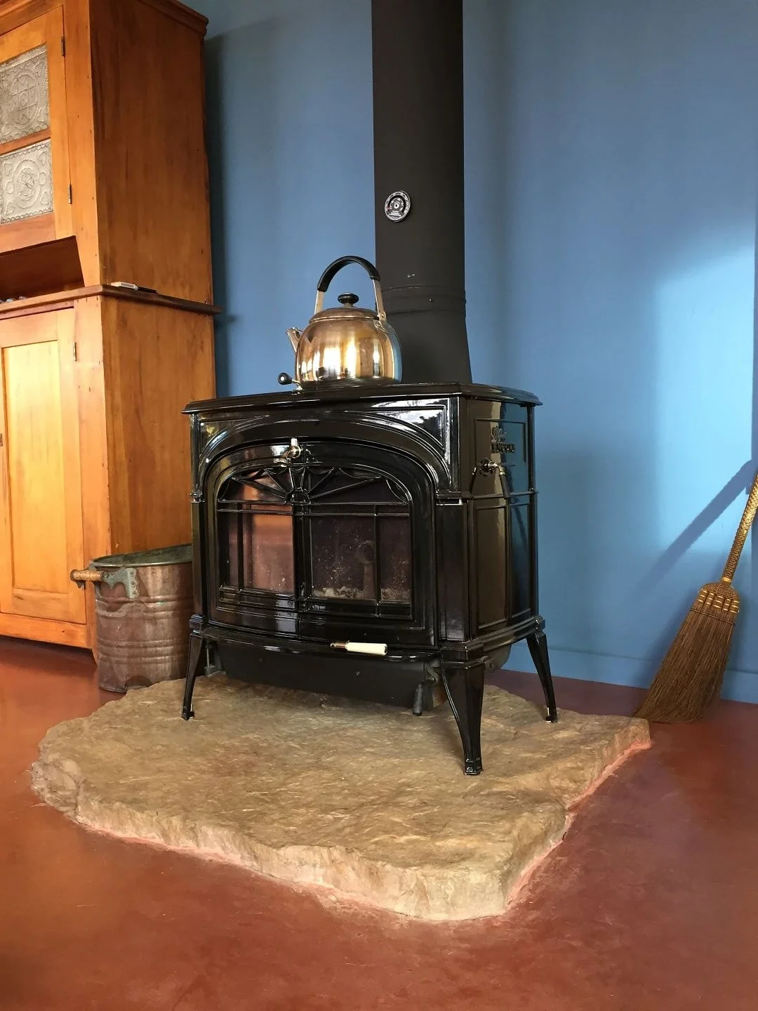 Straw bale homes are a perfect match for using natural building materials. 

In this project, a large, flat rock found right on the building site was carefully chosen as the fireplace hearth. With some thoughtful planning, the concrete slab was poure