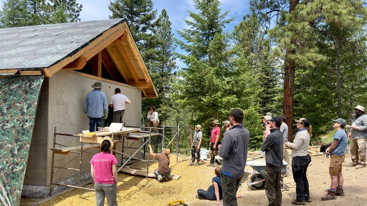 Plaster demonstrationby an instructor at a straw bale workshop.