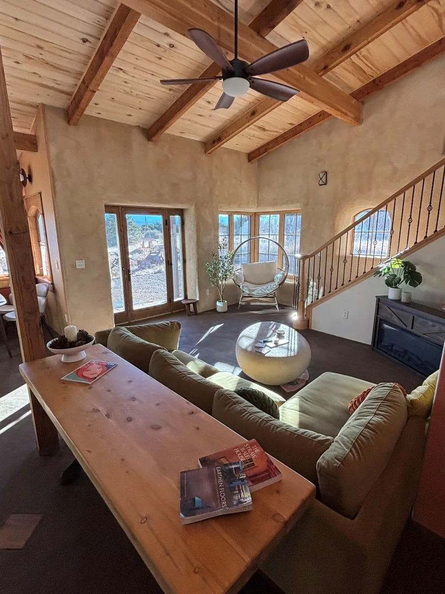 Warm and inviting view of a straw bale homes living room.