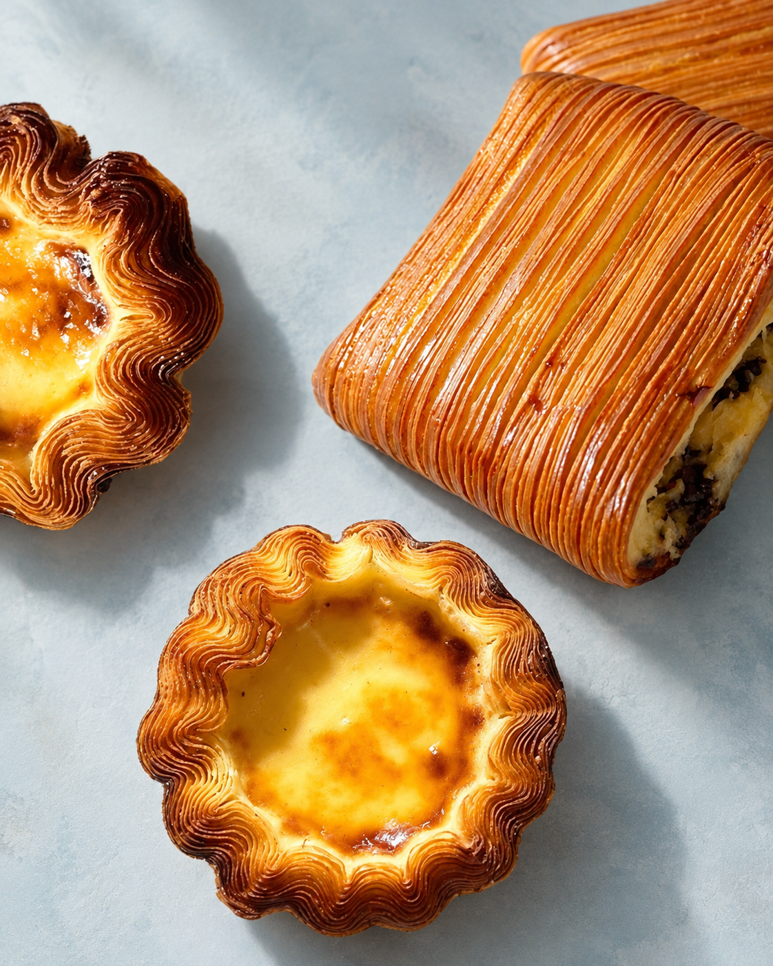 Artisanal Pastries on Blue-Gray Stone.png