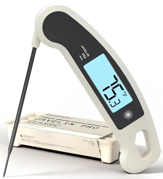 Digital food thermometer displaying 125°F, positioned above a package of cheese on a white background.