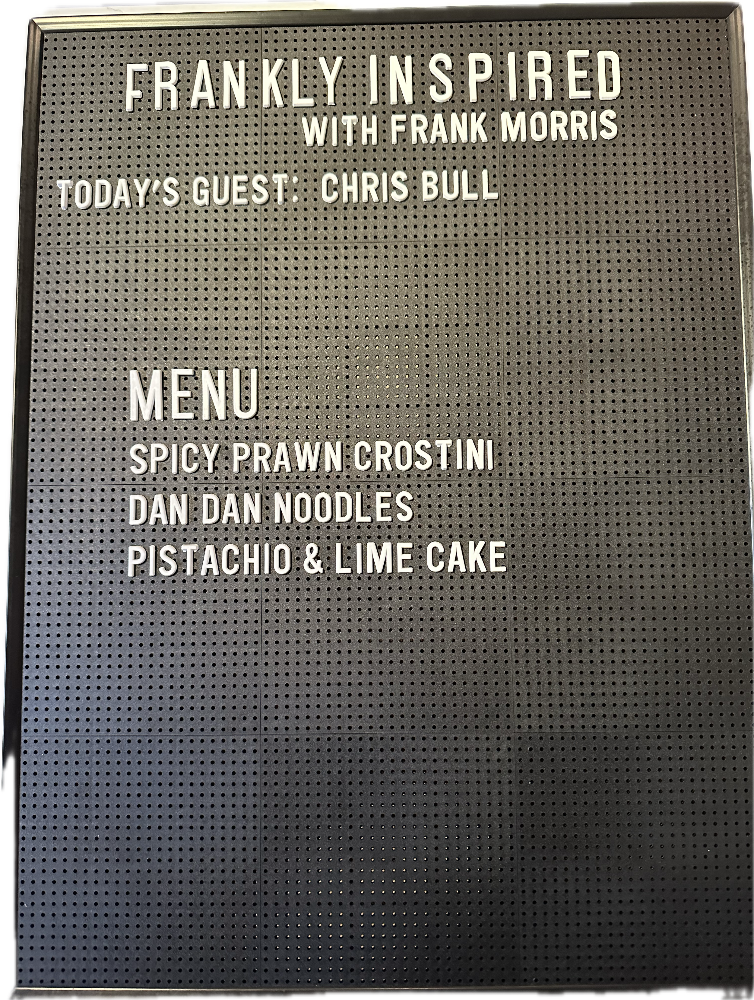 A black and white photograph of a glass window displaying the words 'COMING SOON' in large white letters.