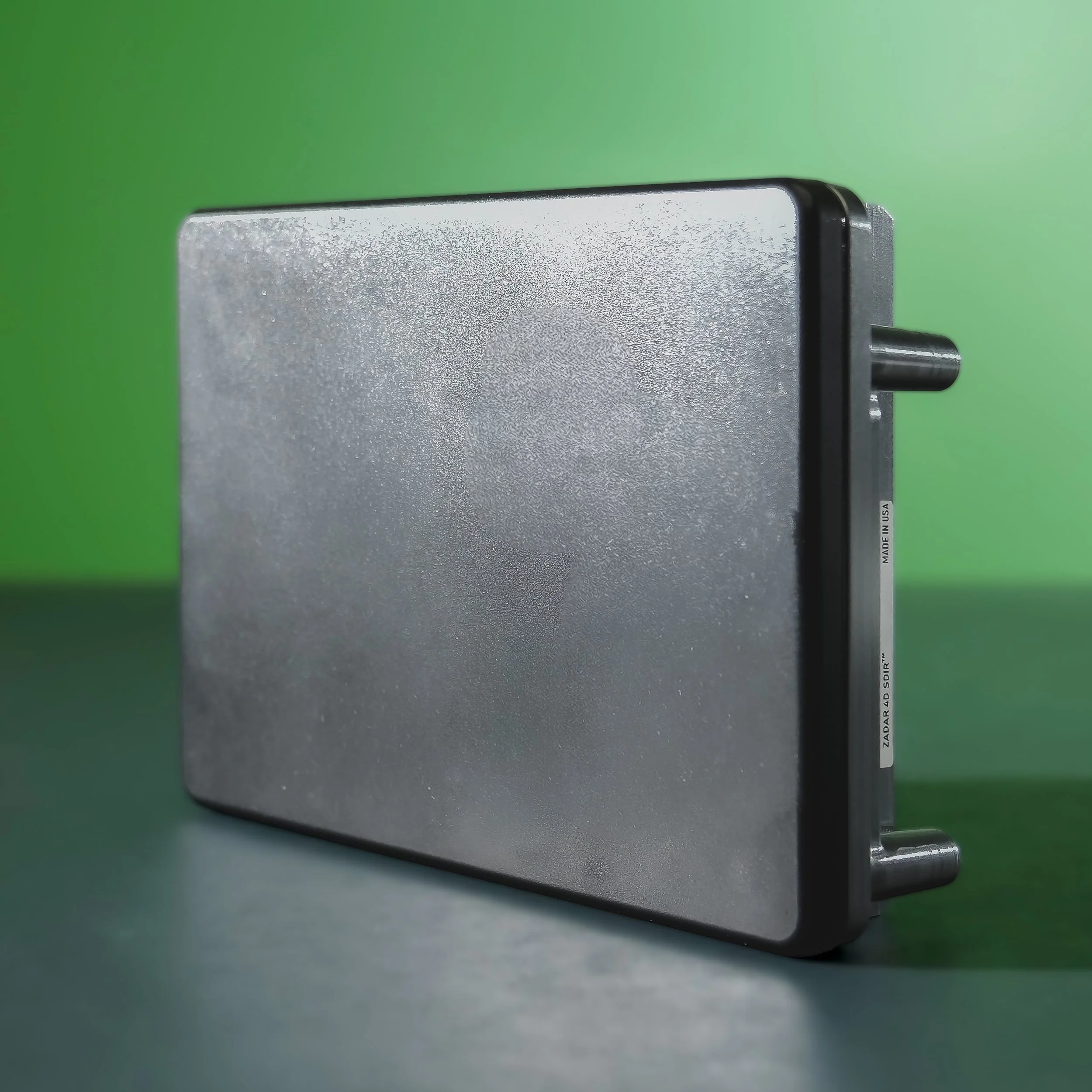 Angled front view of the Zadarlabs zPRIME 3.0 radar showcasing the sensor face and metallic side casing.