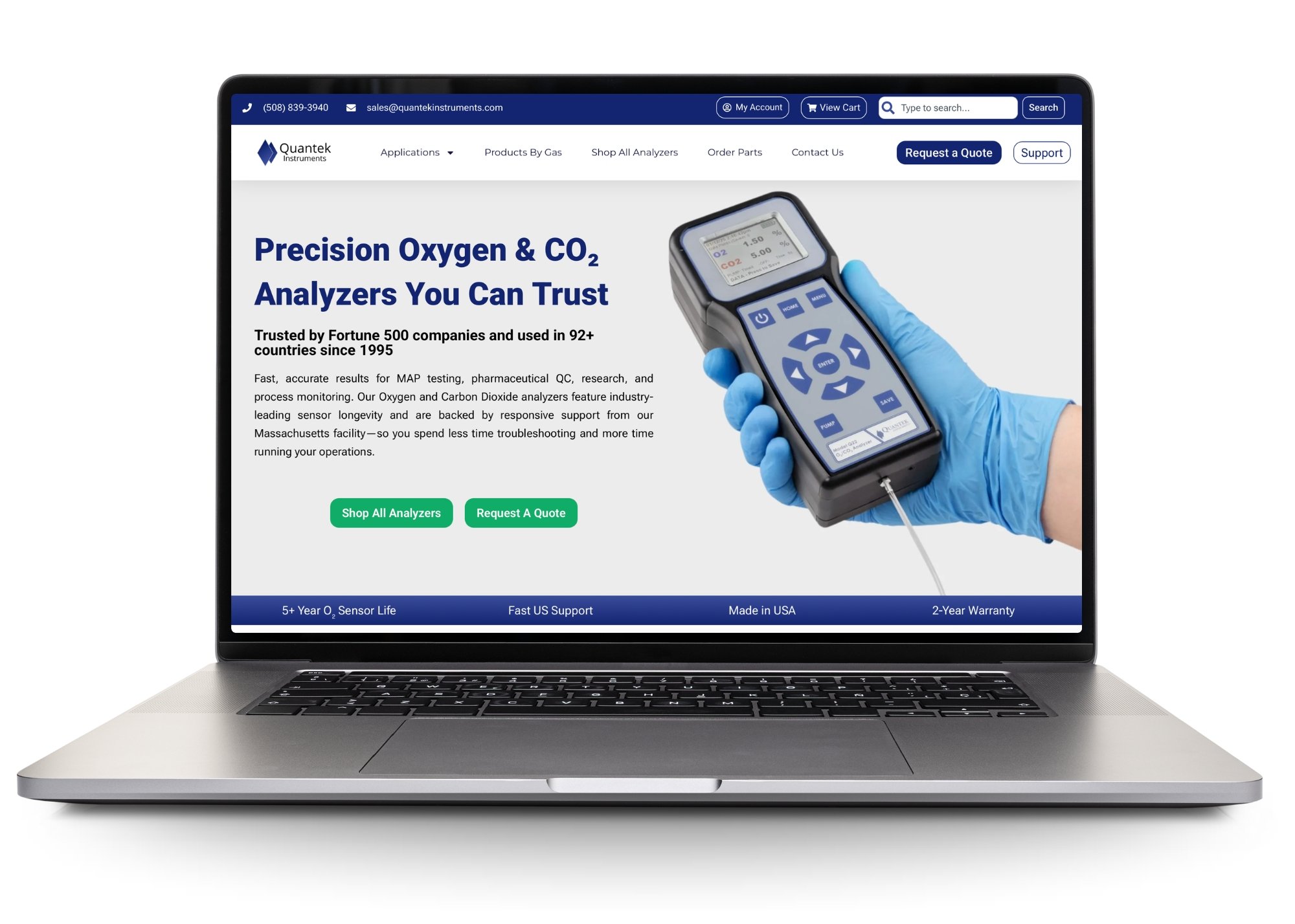 A laptop is open with the homepage for the Quantek Instruments website showing.