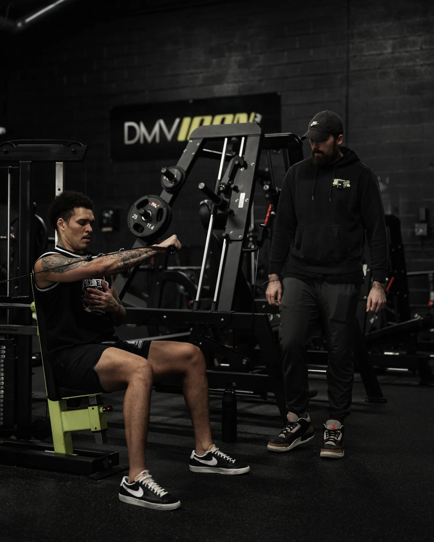 Nick Ridpath observing a client through a seated cable chest press