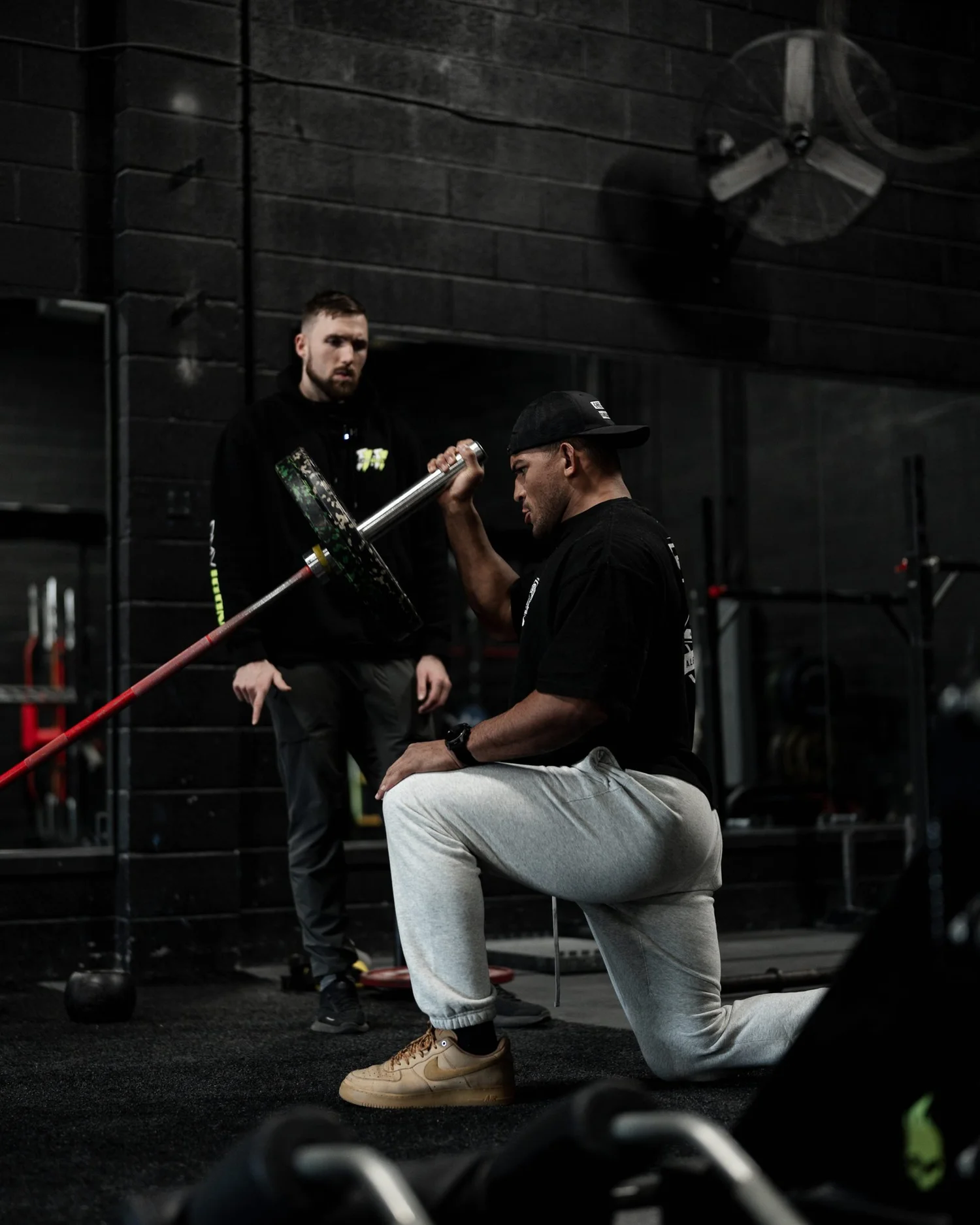 Nick Ridpath coaching a professional MMA athlete through a half-kneeling landmine press