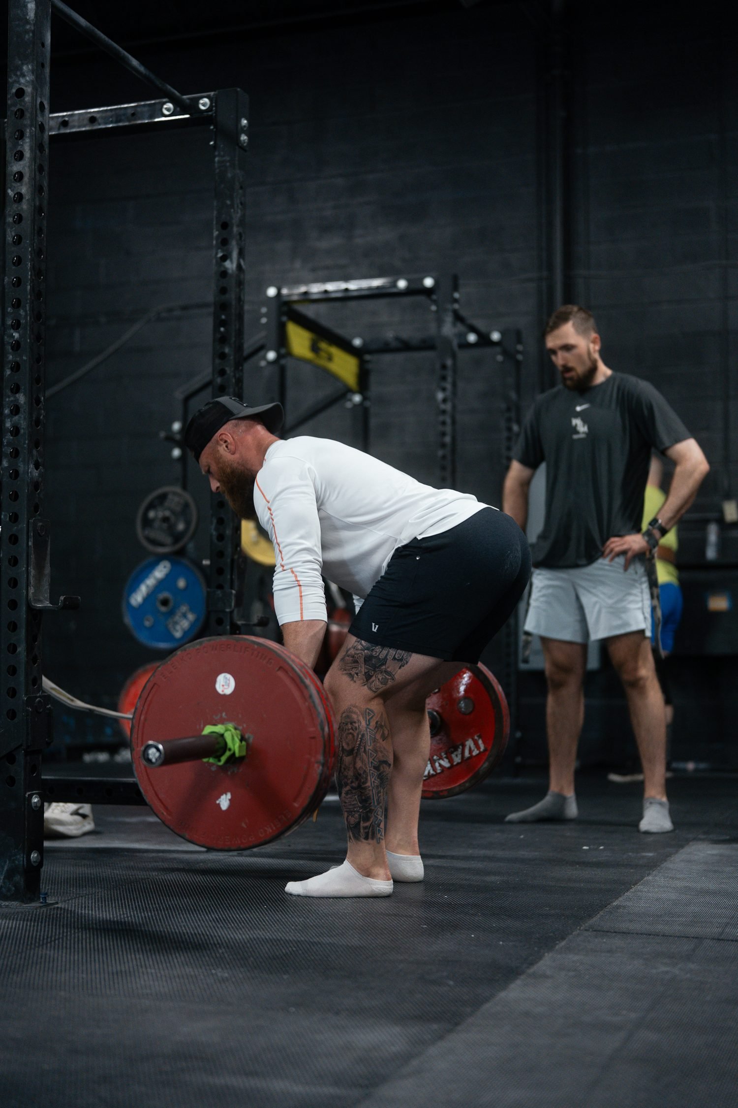 Nick Ridpath watching a lifter's Romanian deadlift and giving feedback on execution