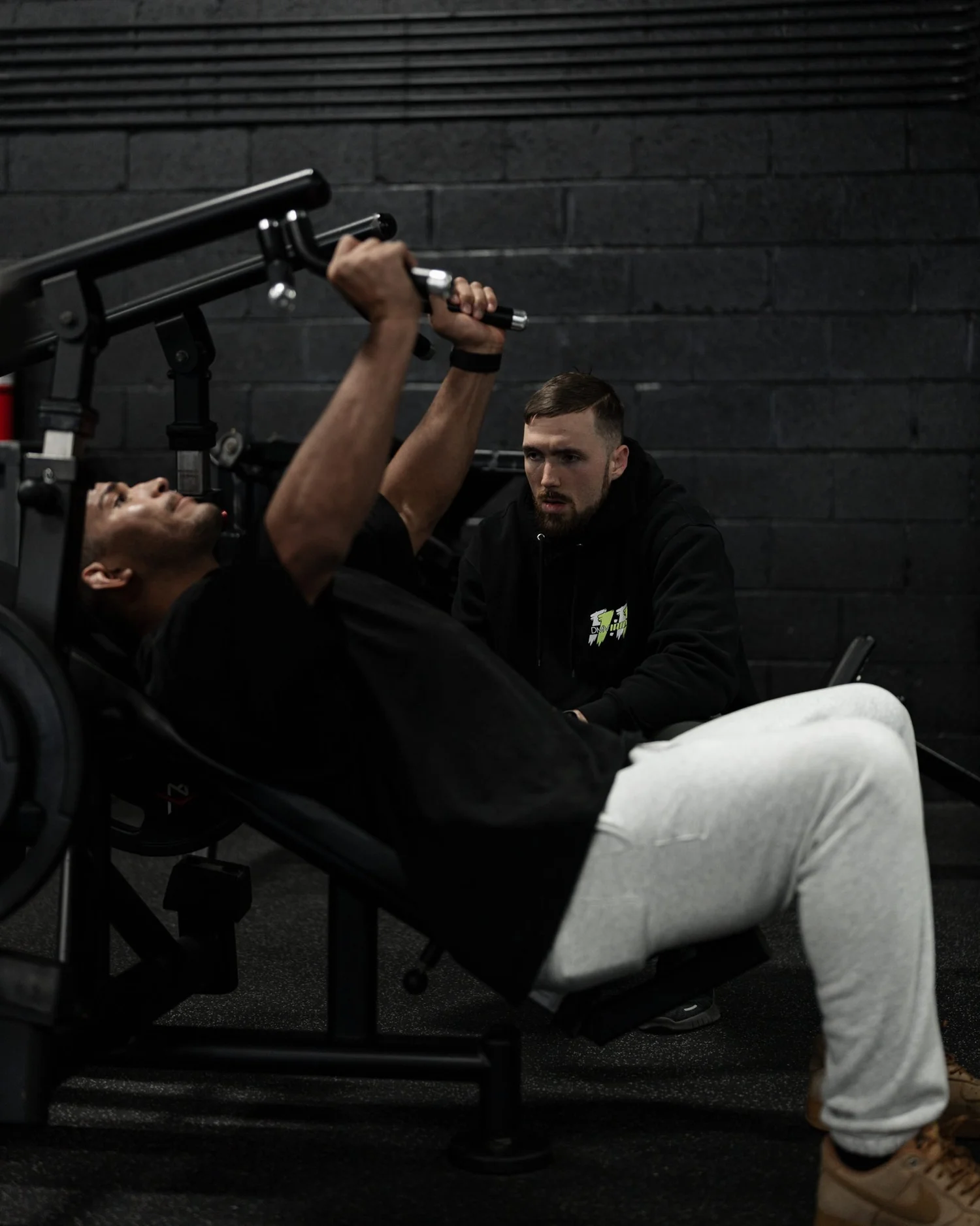 Nick Ridpath watching a client's incline press up close during a coaching session