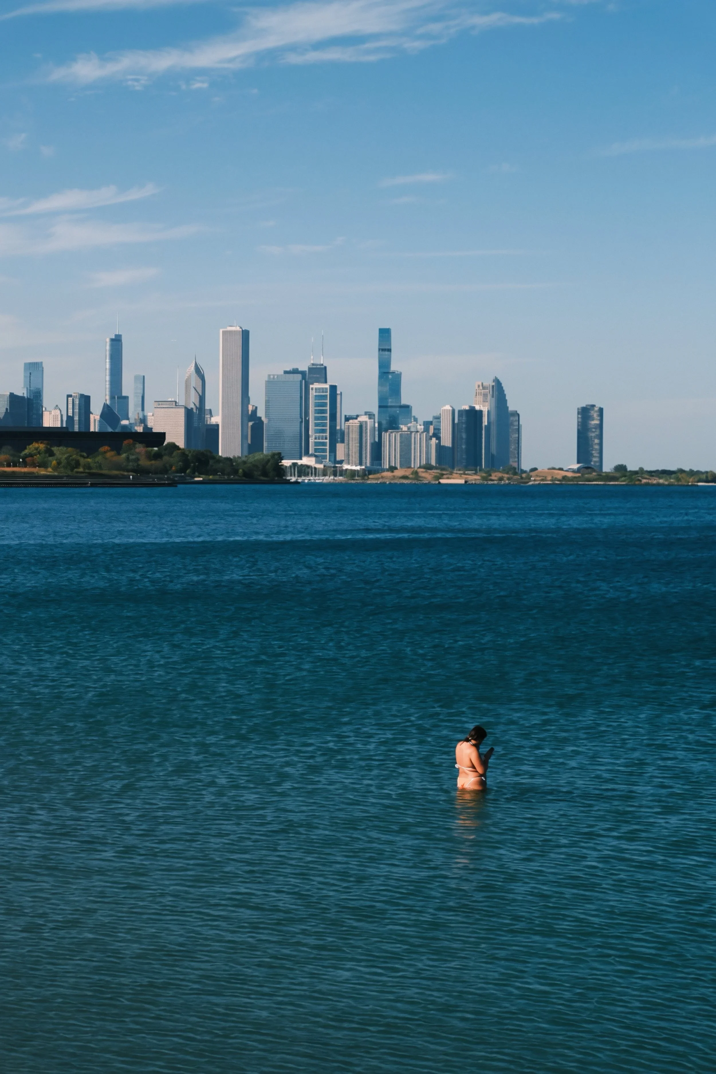 A swimmer in the lake with the Chicago skyline behind