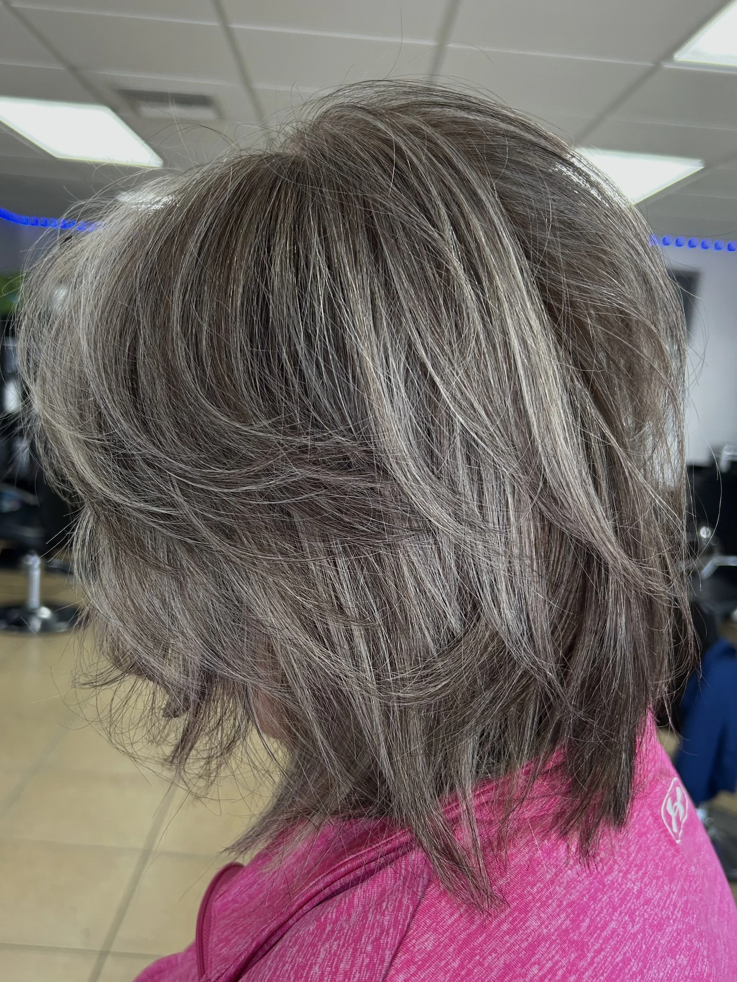 after image of a client with blonde hair growing out and grey blending the hair at the roots