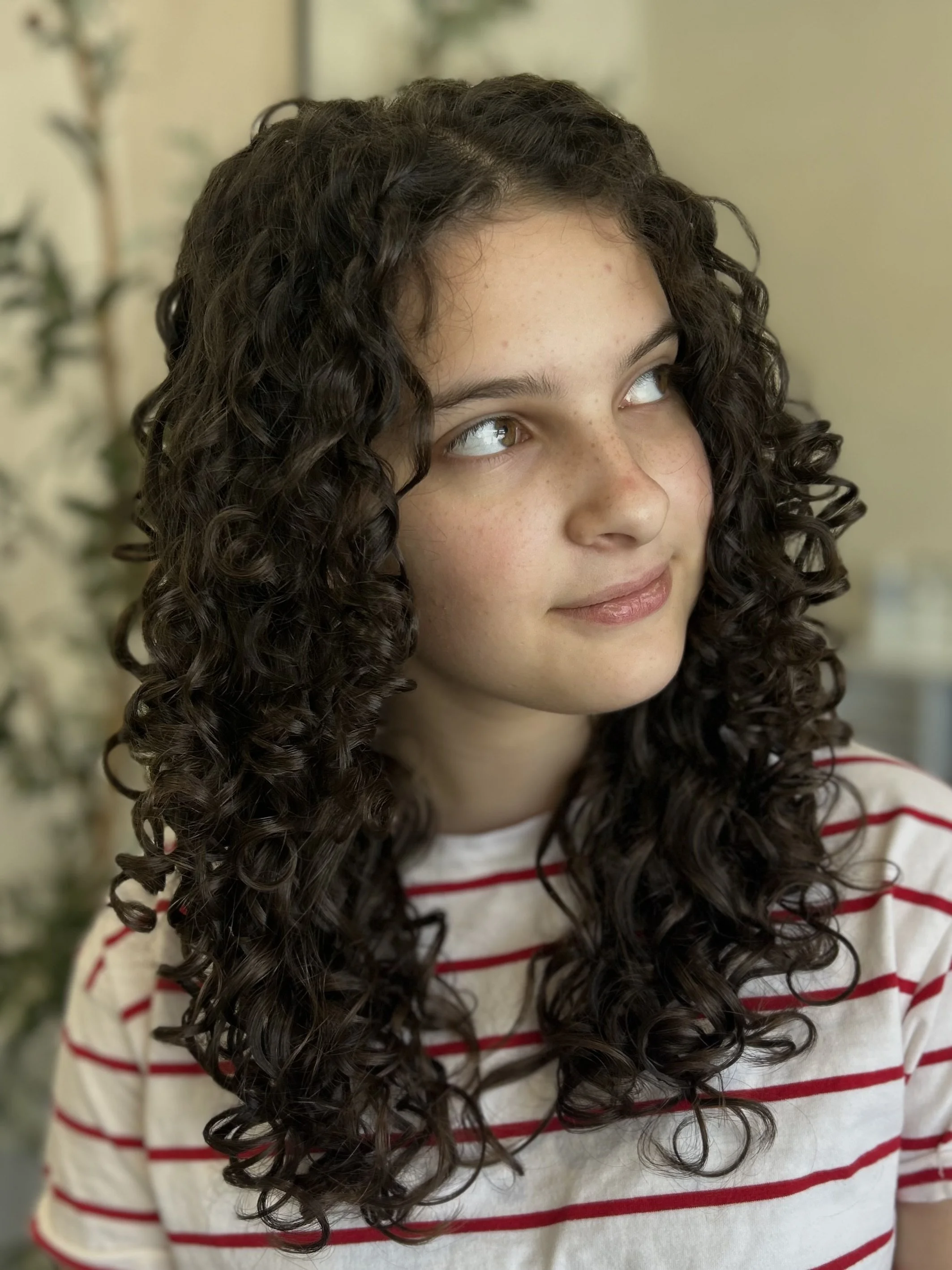 Long curly cut on dark brown hair in Sarasota 