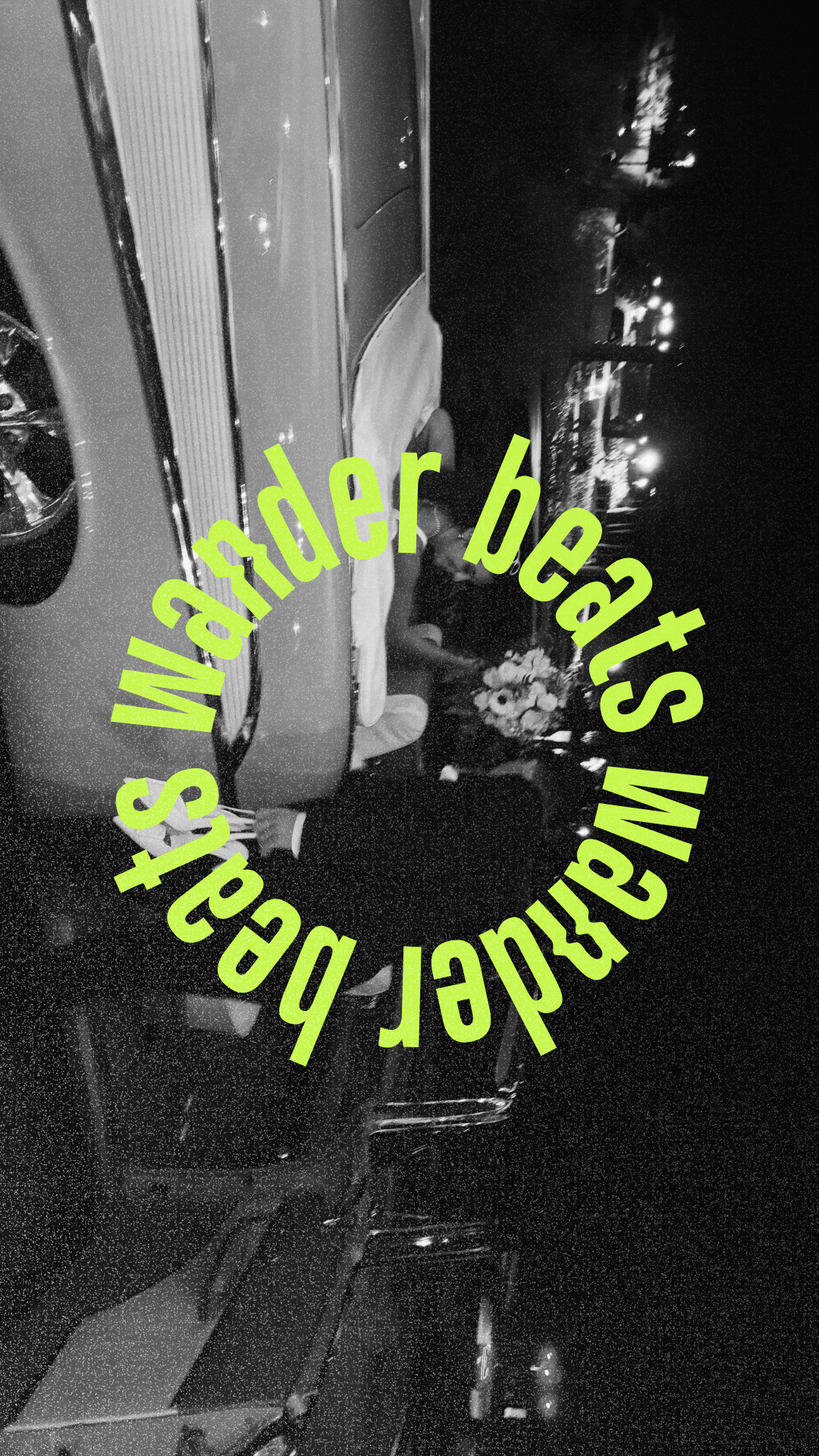 A wedding reception scene showing a bride and groom sitting at a table with a floral centerpiece, with city lights visible in the background at night. The image is in black and white with green text overlay that reads 'Wander beats Wkstation beards'.