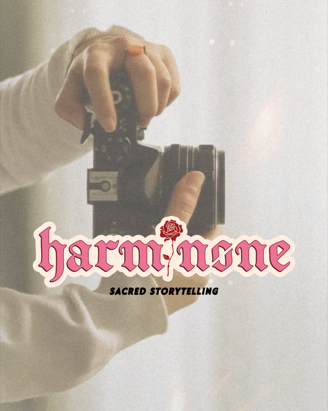 A photographers logo reading "HarmNone" in a girly pink blackletter font that seems 3D with a rose. Overlayed on a photograph of a womans hands holding a camera.