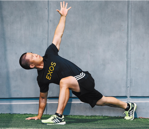 A person performing a movement prep stretch called the world's greatest stretch