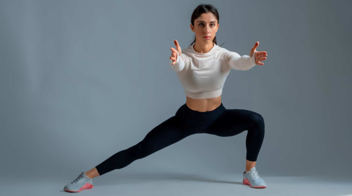 A person performing a lateral lunge movemement prep exercise