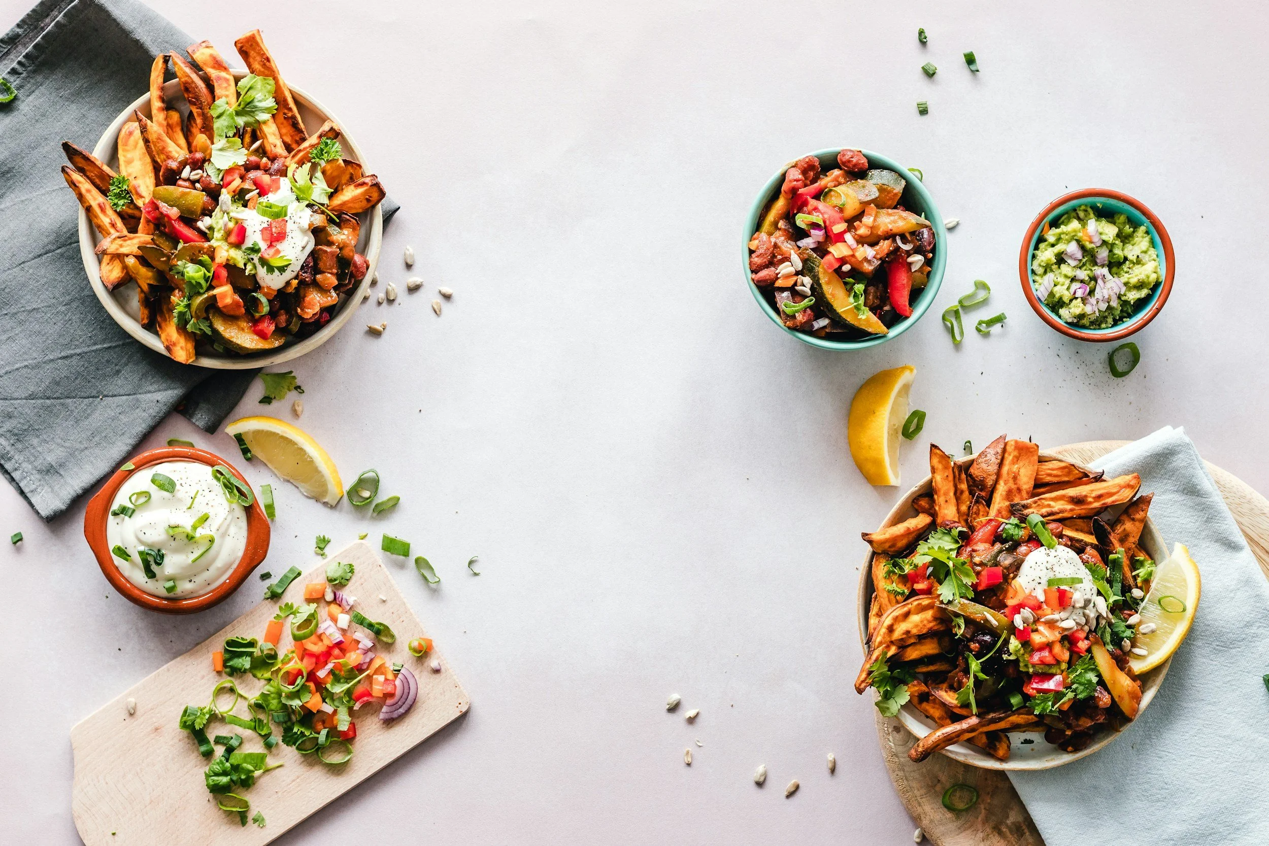 A few colorful bowls for foot and fresh vegetables and herbs.