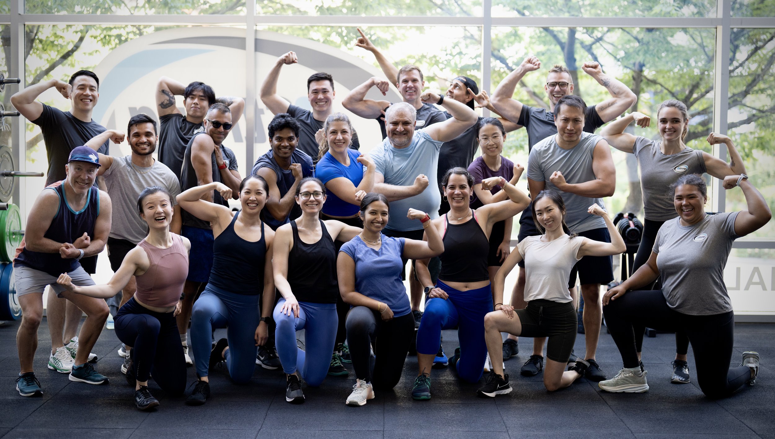 Group shot of 20 bStrong members smiling and flexing