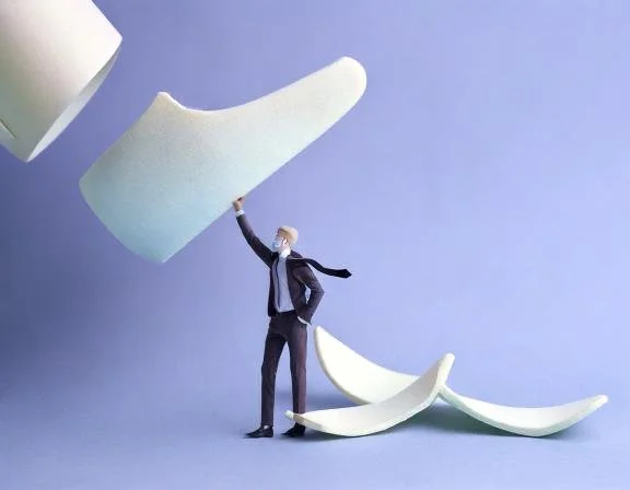 Foot treading on a banana and a person helping to stop them