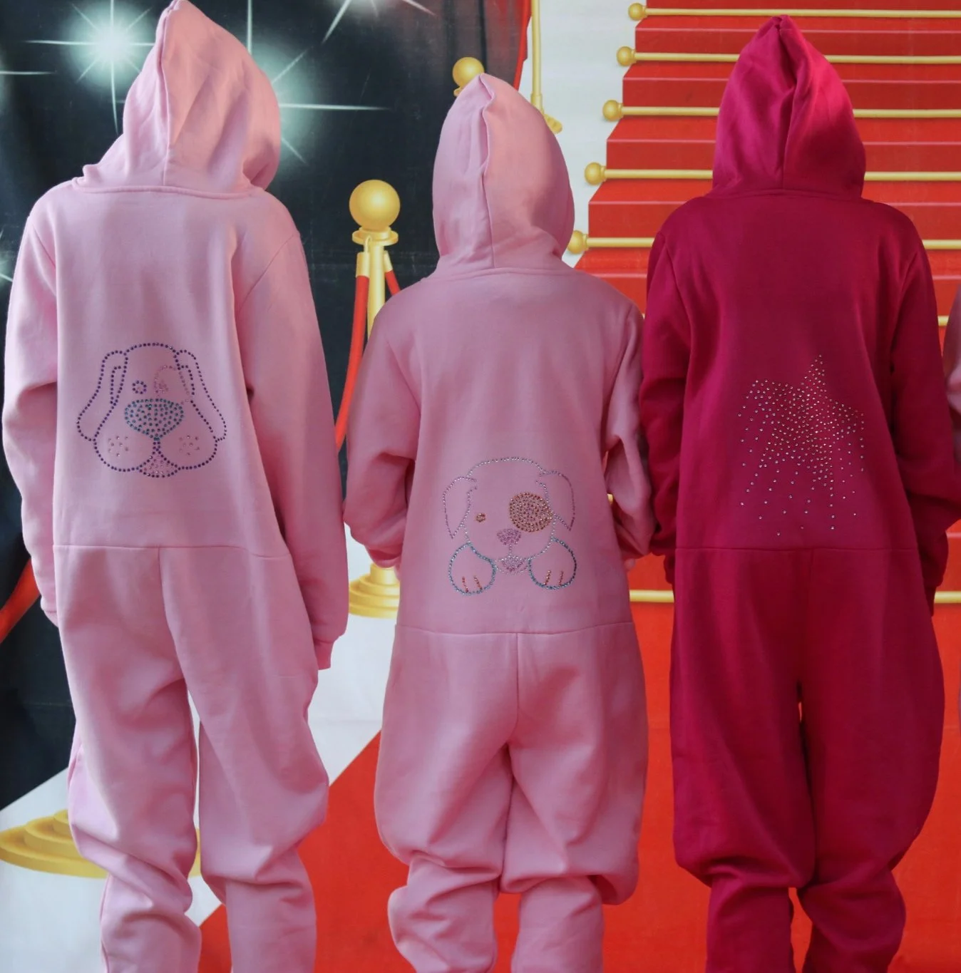 Girls posing wearing onesie