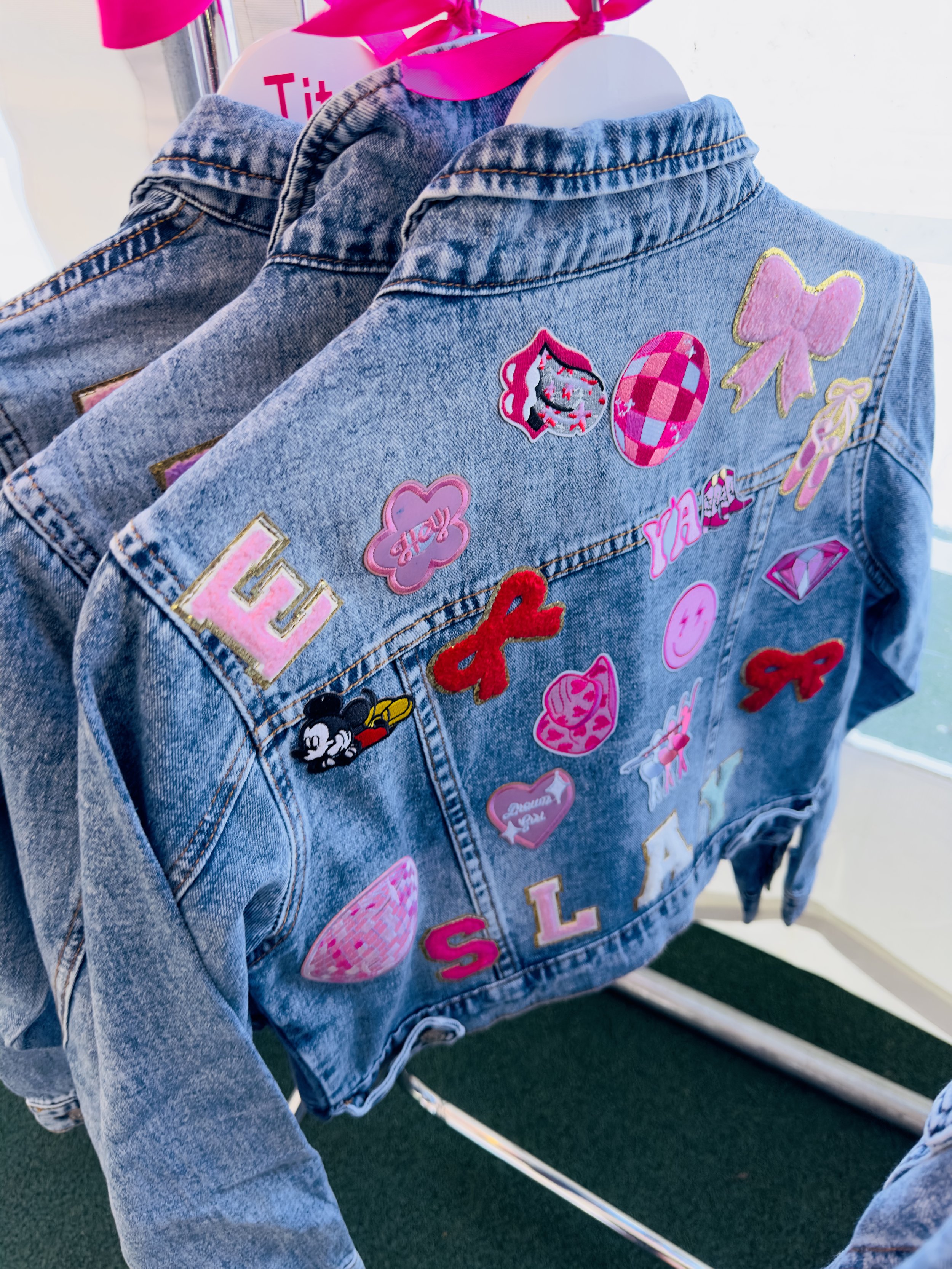 Personalised denim jackets with colourful letter, heart and star patches at a Luvlybubbly denim jacket party.
