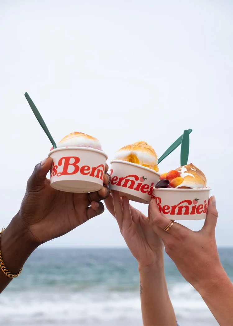 Guests toasting with Bernie&rsquo;s cups by the ocean