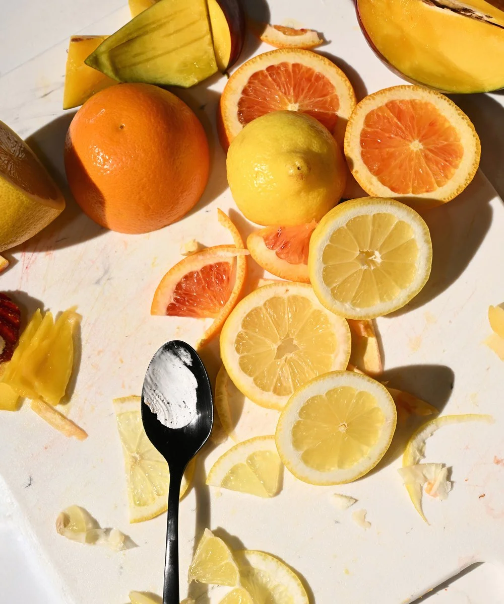 Fresh citrus — oranges and lemons sliced on a board