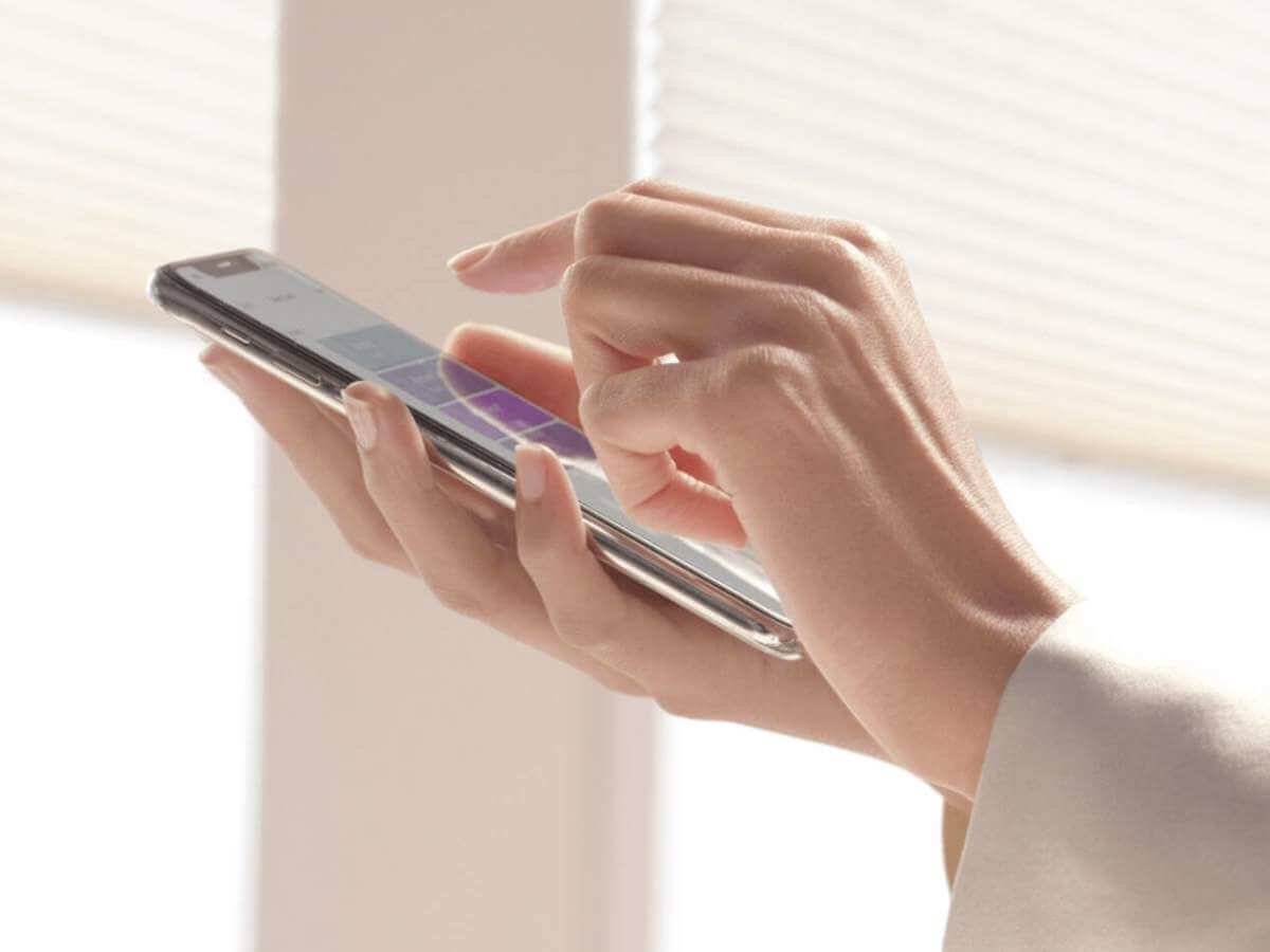 Hunter Douglas Powerview Smart Shades being controlled on an app on a smartphone.