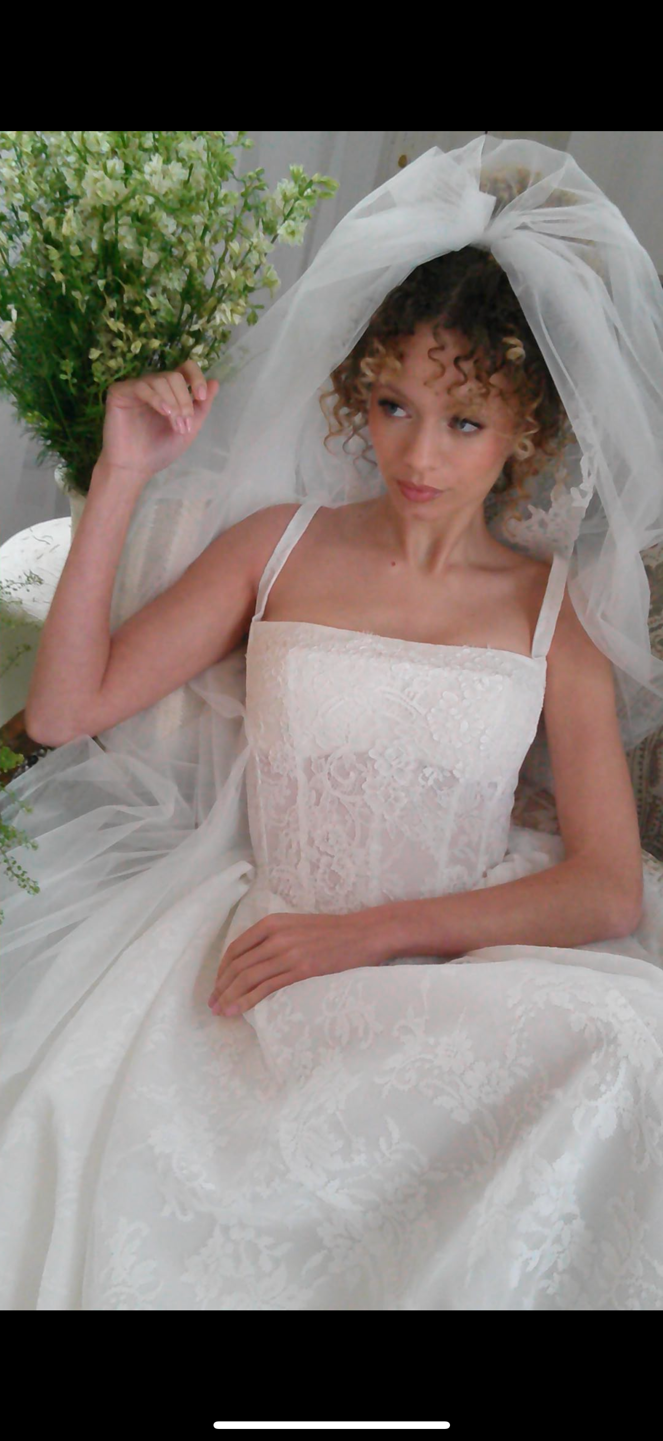 Eiffel Tower in Paris with nearby buildings and street view, featuring cars and pedestrians, black and white photo.