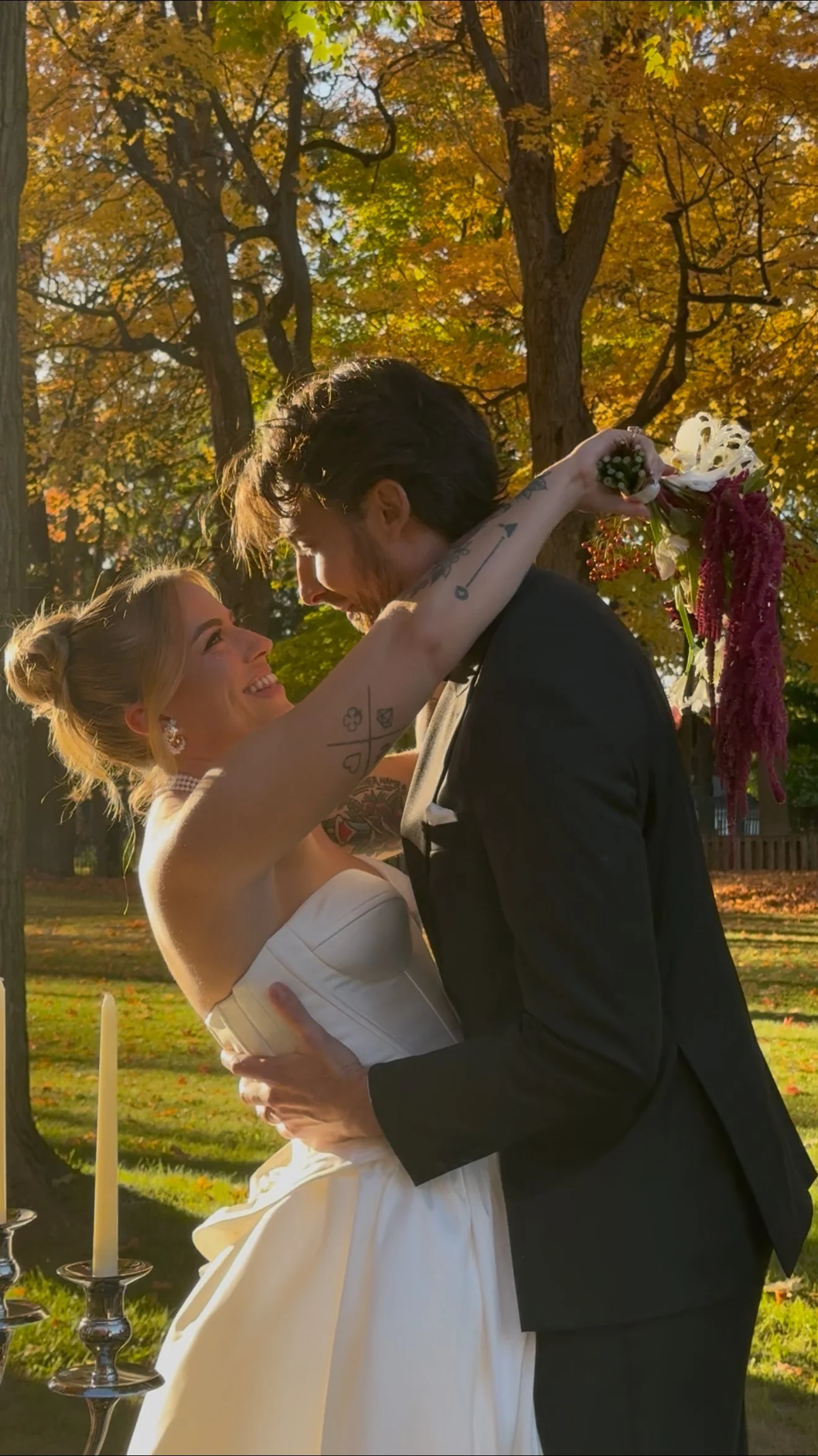 Silhouette of a bride in a wedding dress standing by a door with a decorative glass window.