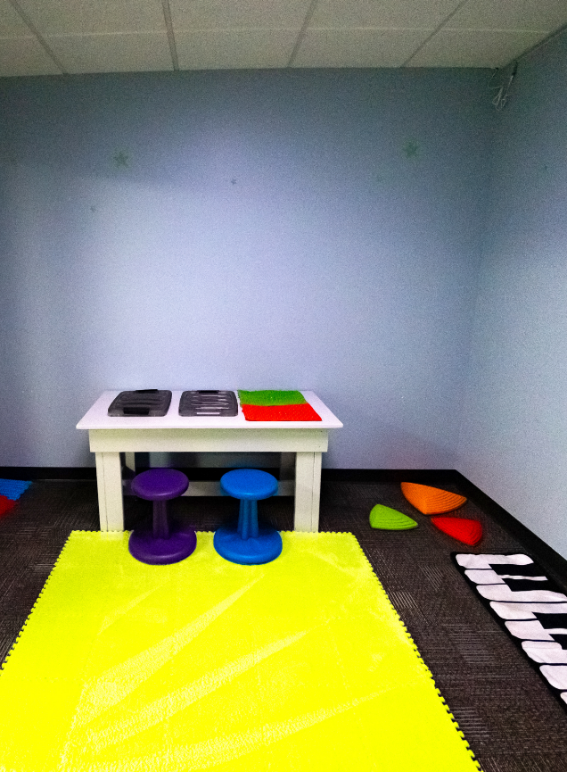 Group learning room with tables and chairs at the MBS ABA Learning Center