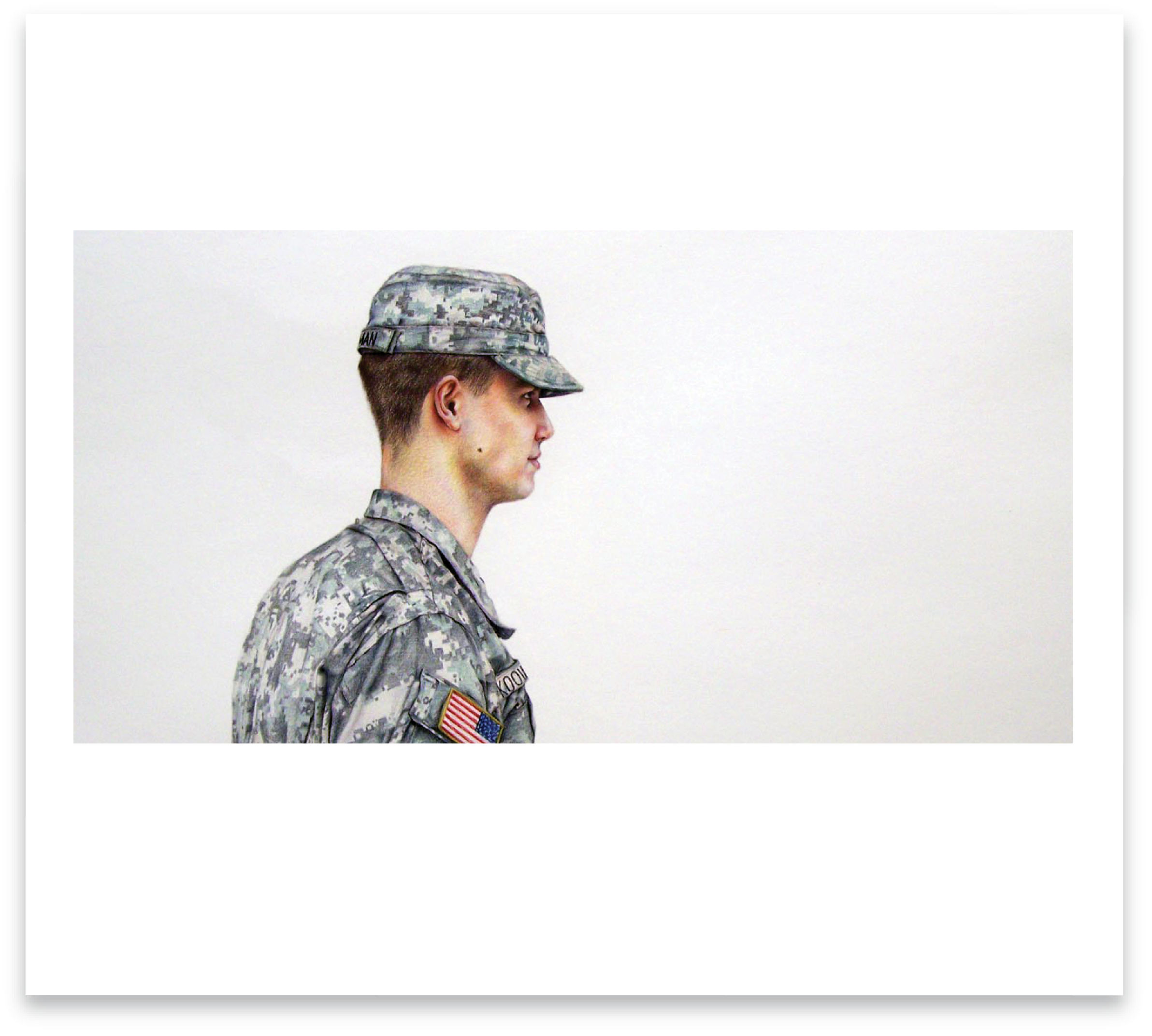 Side profile of a young US male soldier in camouflage uniform and cap.