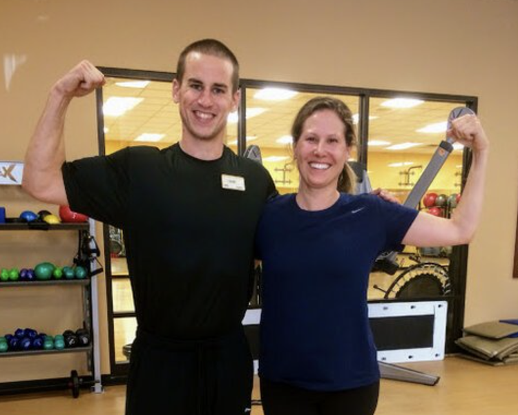 Sam Moses and a mom client flexing in the gym