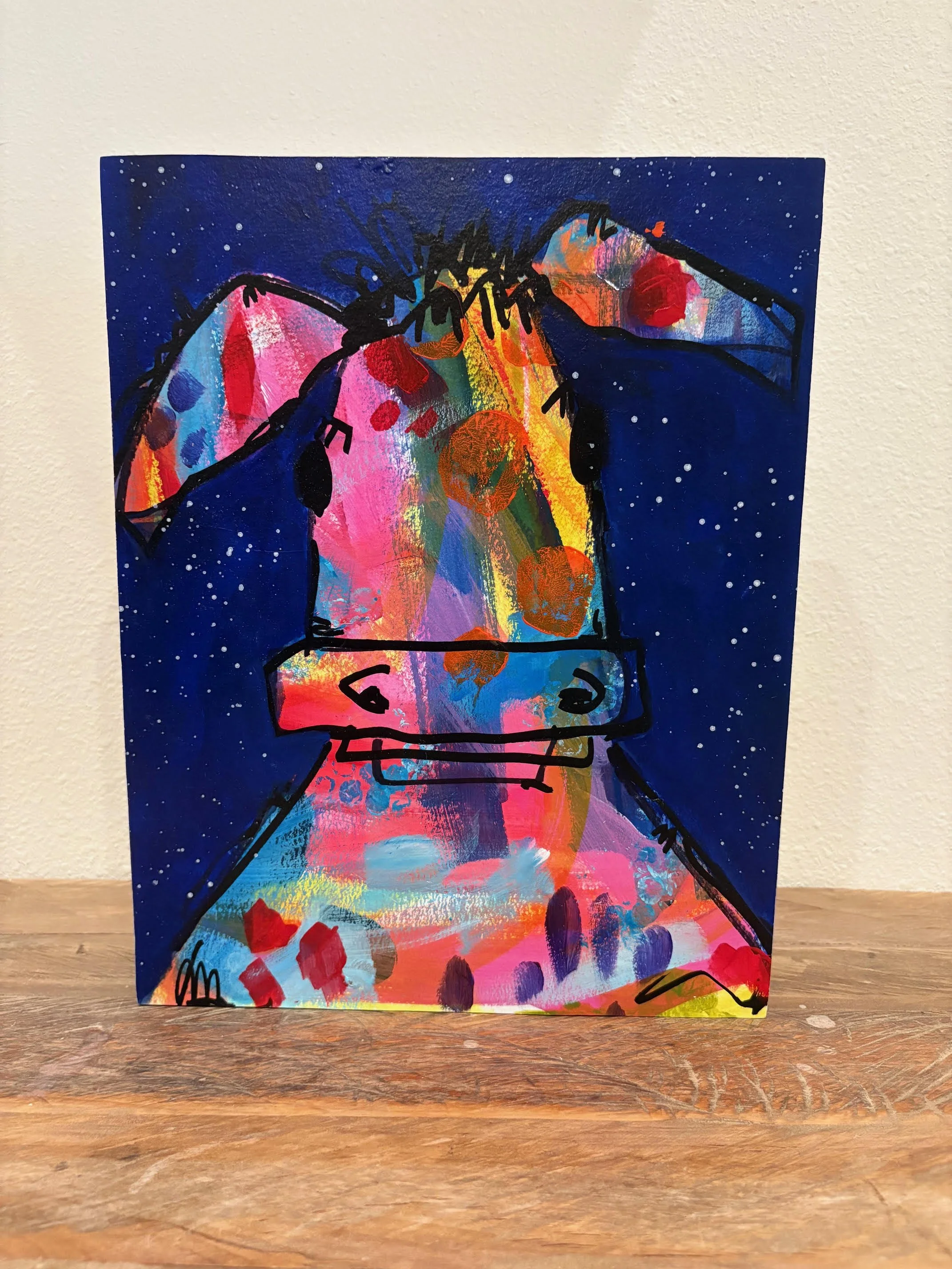 a painting of a colorful cartoon cow