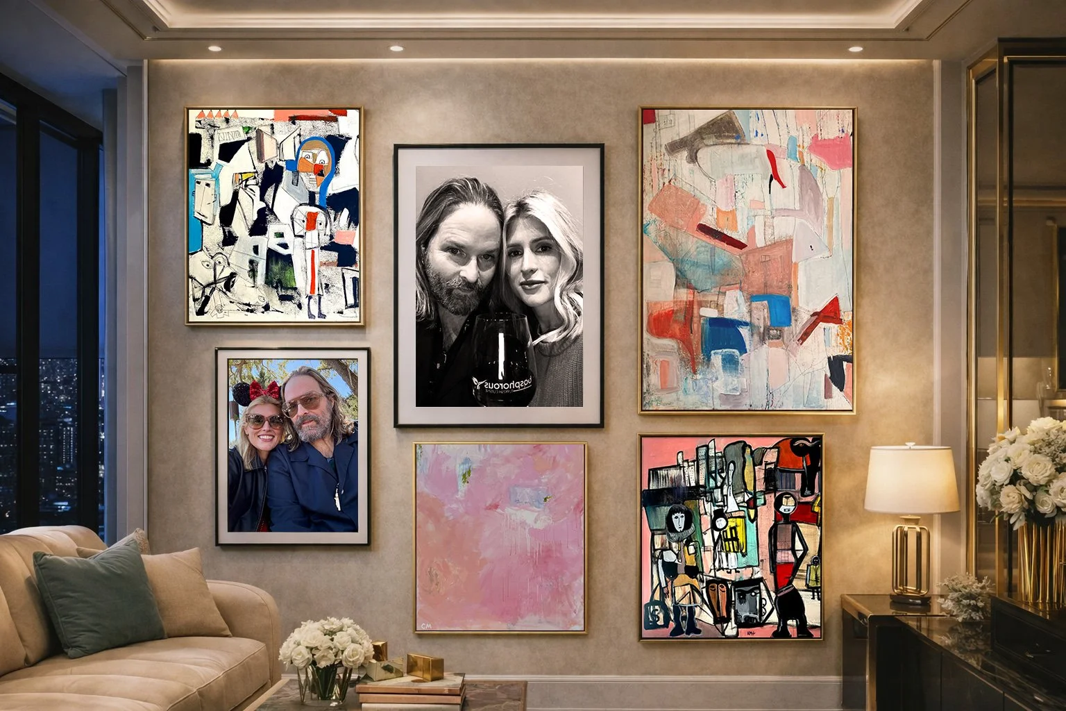 Framed abstract paintings and portraits arranged in a modern living-room gallery wall installation.