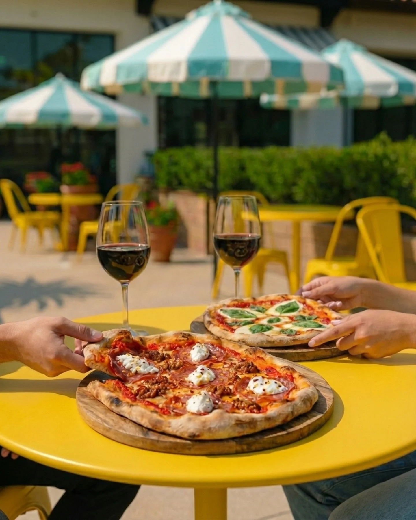 A sunny table, two Roman pinsas, and zero regrets.

Meet our duo: The Spicy Sicilian bringing that bold Calabrian heat, and The Queen Margherita keeping it classic with bright tomato, mozzarella, and basil. Crisp, airy, and irresistibly light&mdash;m