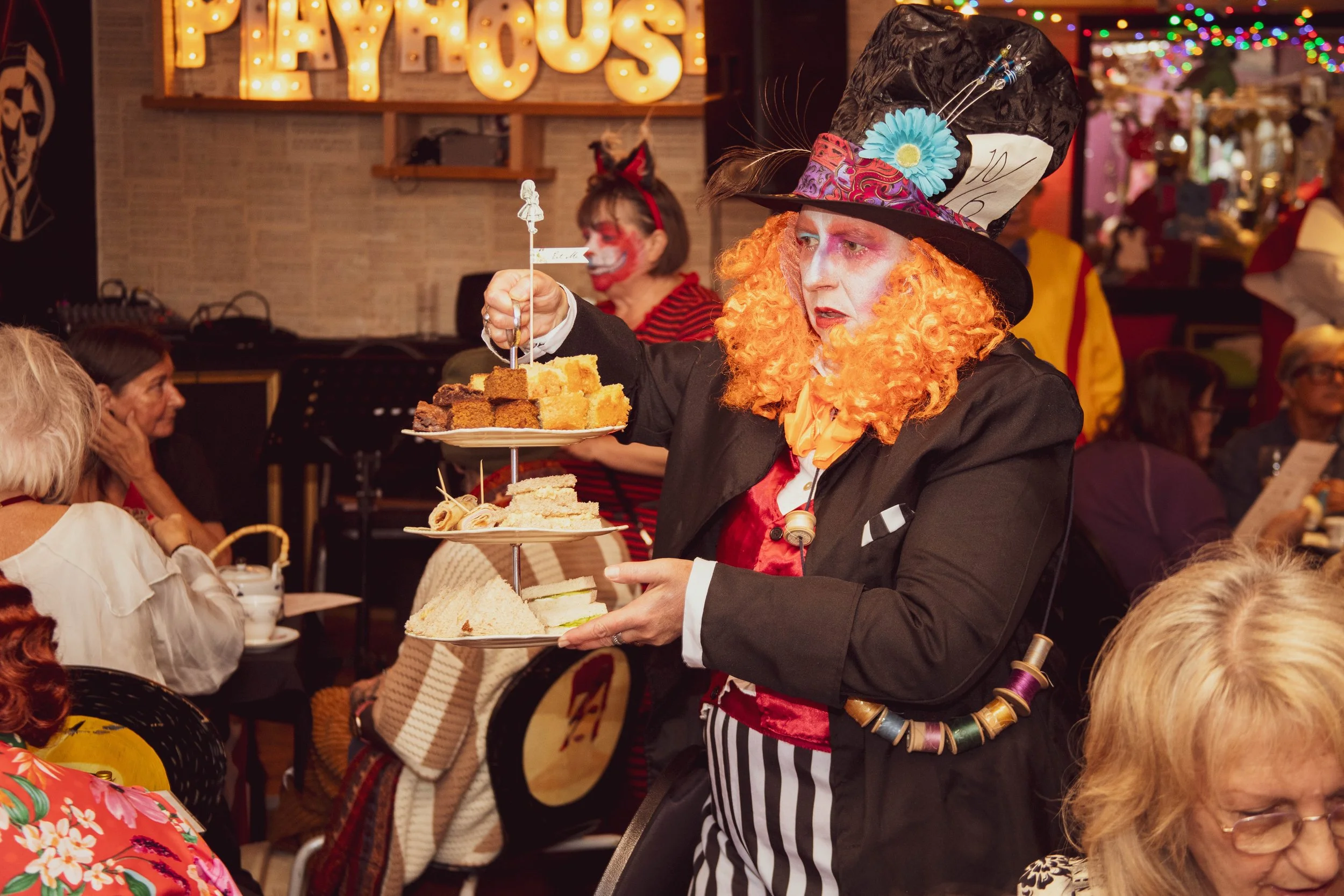 the mad hatter service cake at a fundraising tea party