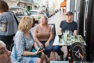 Three Creative Eastbourne members sat outside Printers Playhouse