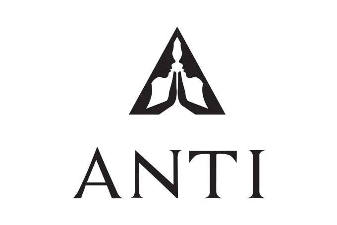 Anti Logo featuring two silhouetted faces in profile with hands together, forming a triangular shape, and the word 'ANTI' written below.