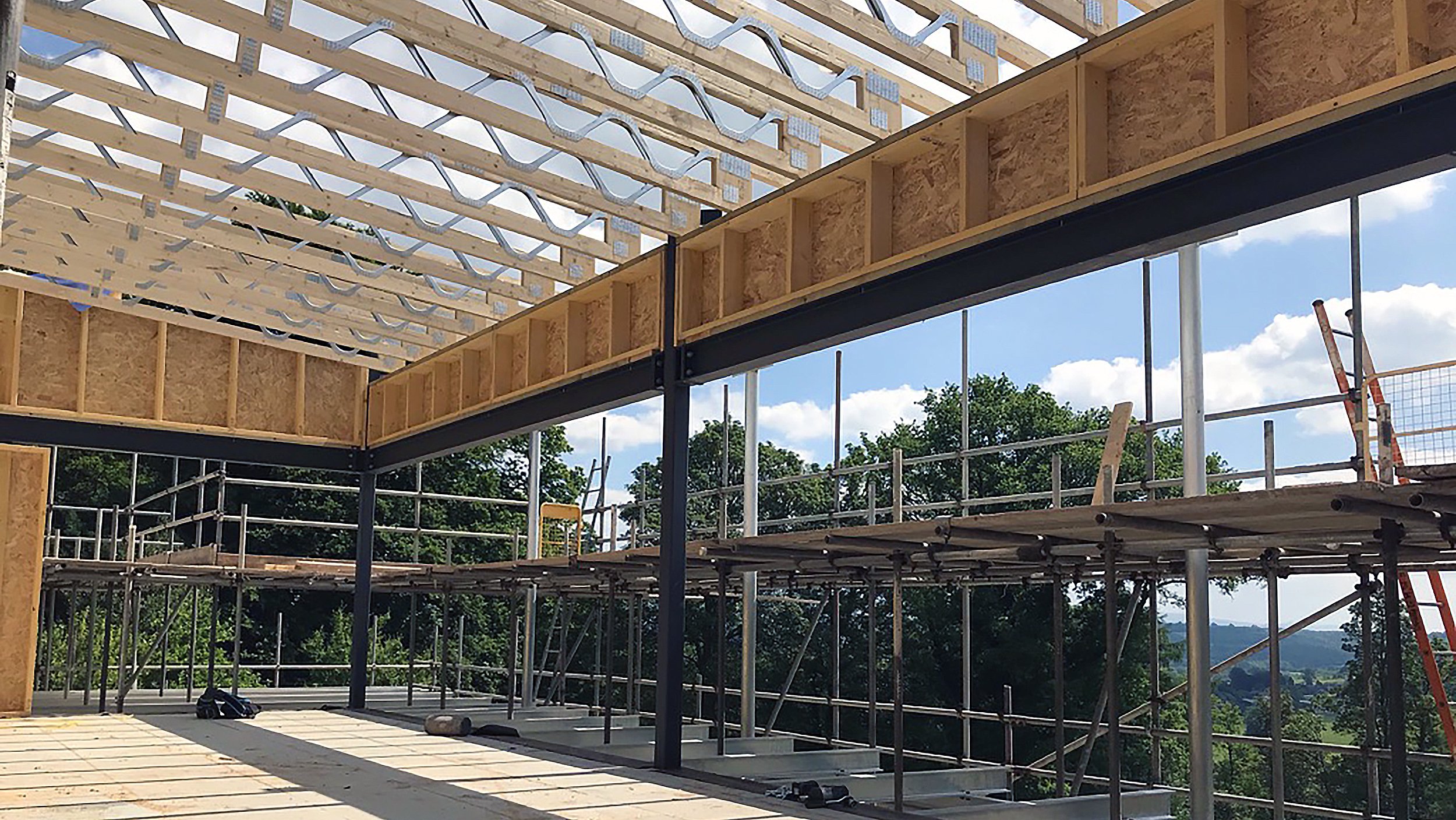 Builders in Wales erected a timber and steel frame in Cumbria. Posi-joists. Large timber frame. Near Welshpool and Shrewsbury