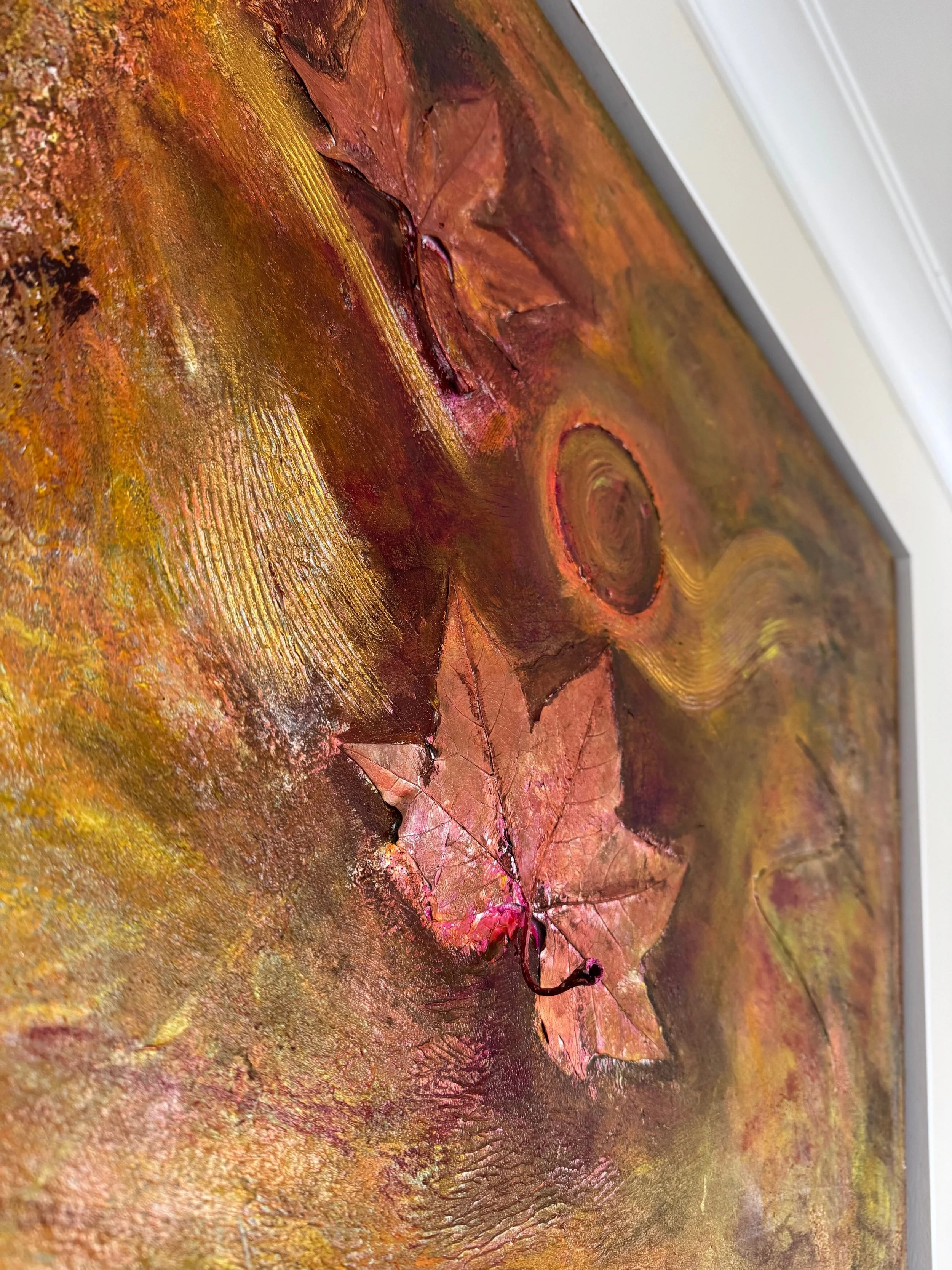 Close-up of a textured painting featuring autumn leaves with rich brown and orange tones.