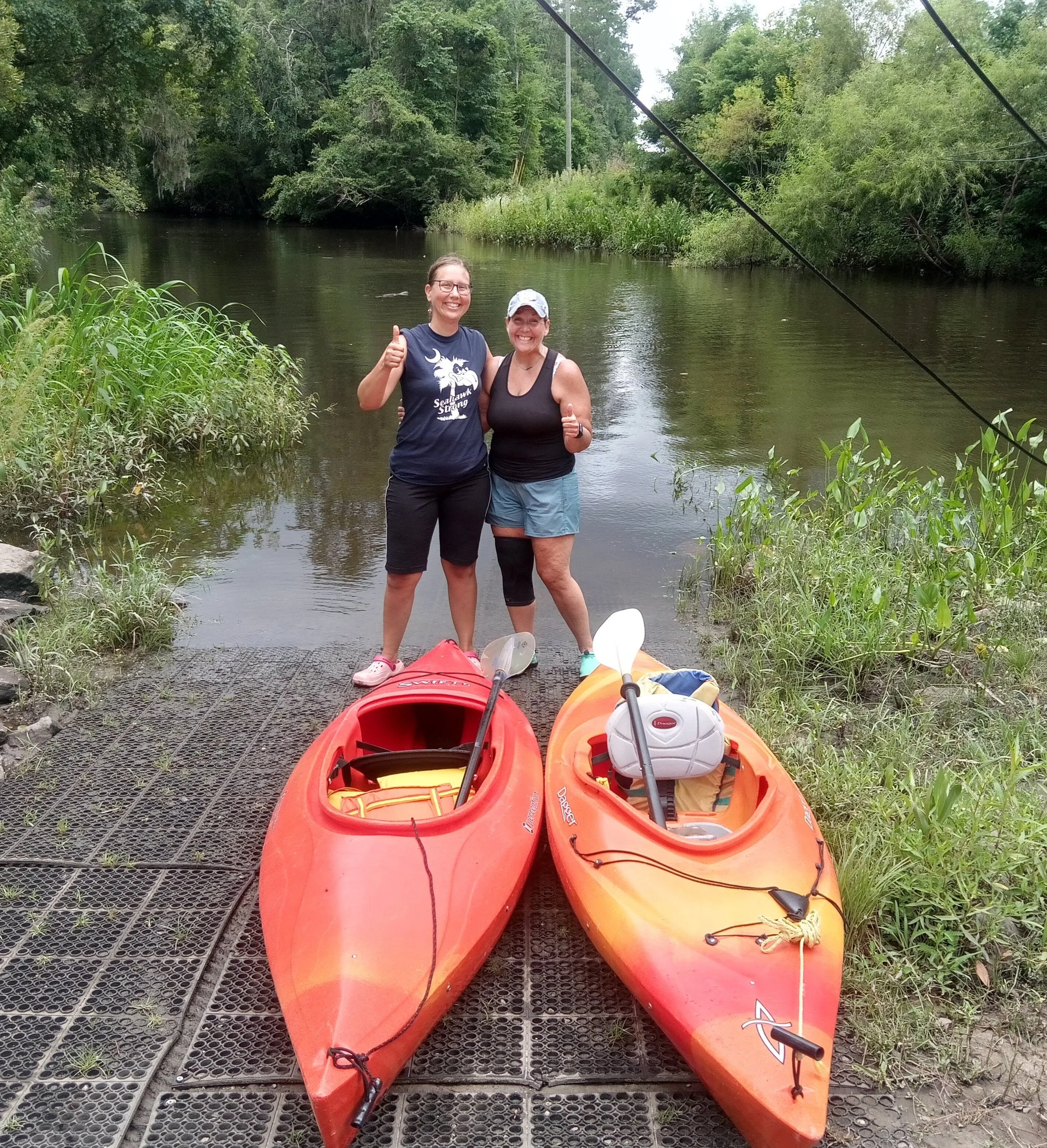 Mary Kathleen by the river with kayaks, representing a fresh start and forward movement