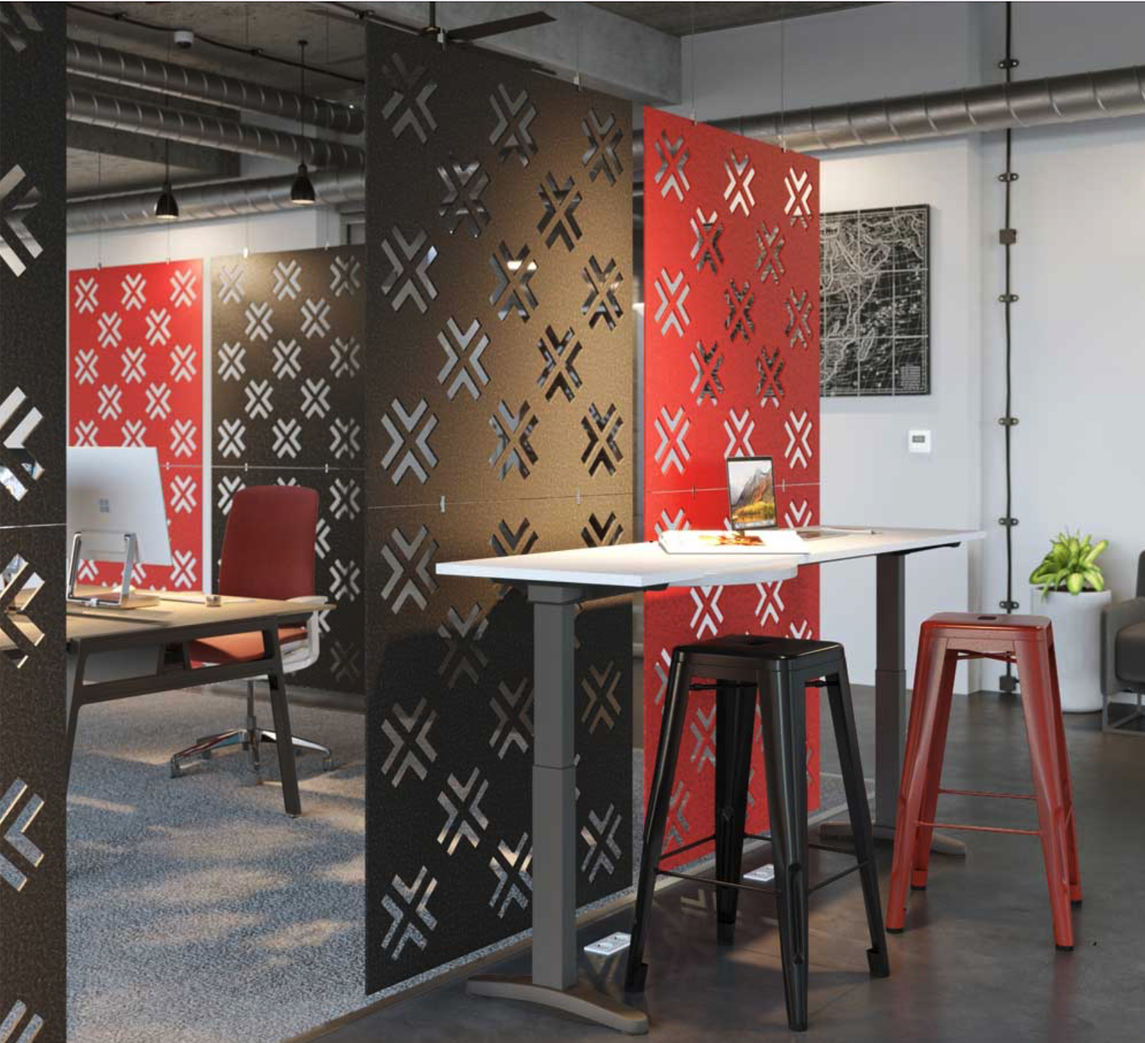 Modern office space with partition panels decorated with geometric patterns, a white table with stools, an office chair, computer, and artwork.