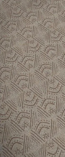 Patterned textured surface with geometric designs of lines and dots.