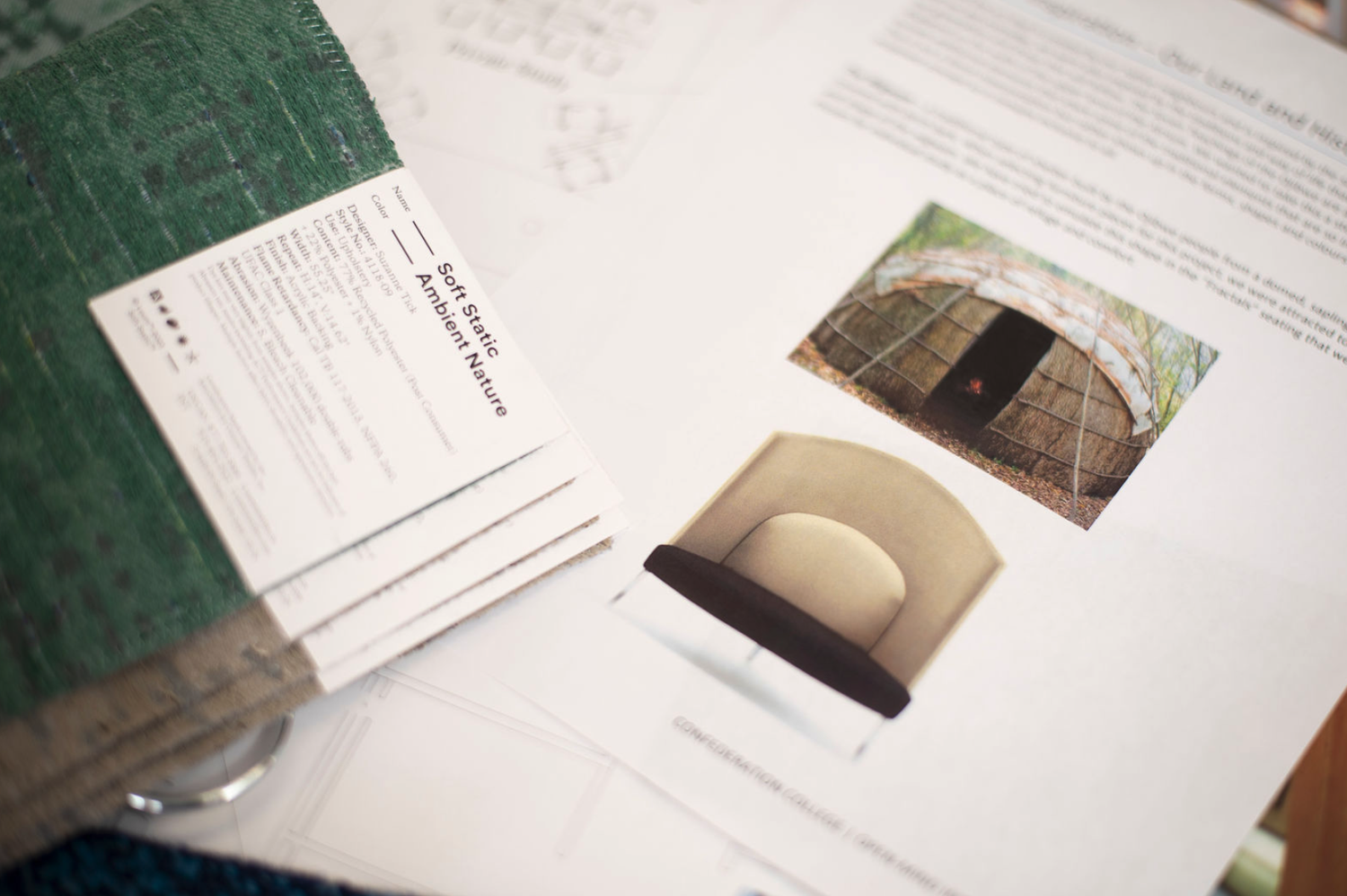 A display of informational cards and images about a green, dome-shaped, possibly earth-shaped structure made of earth or clay, with an entrance, set in a natural outdoor environment.